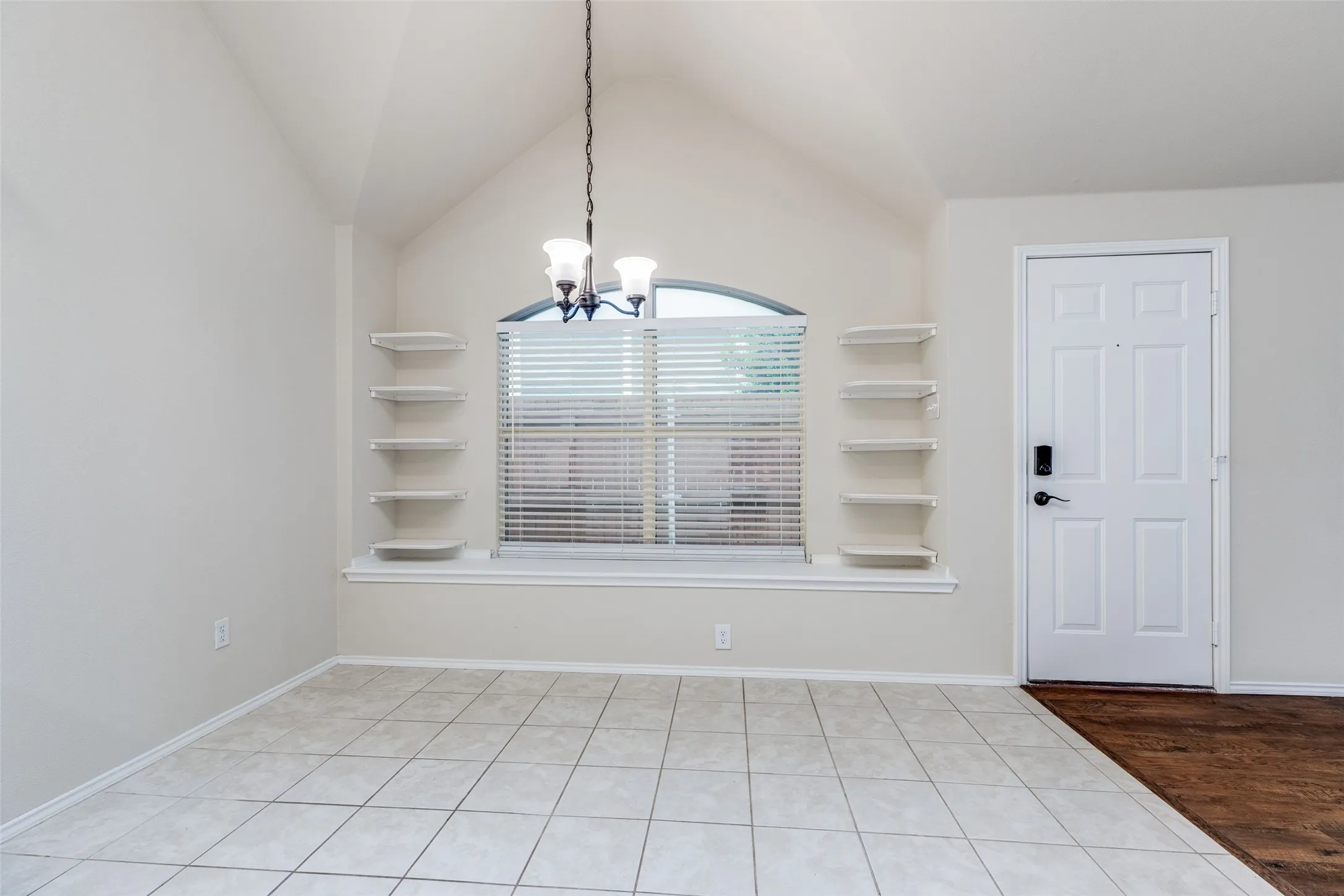Breakfast nook, with built-ins and window seating, is open to both kitchen and larger living area.