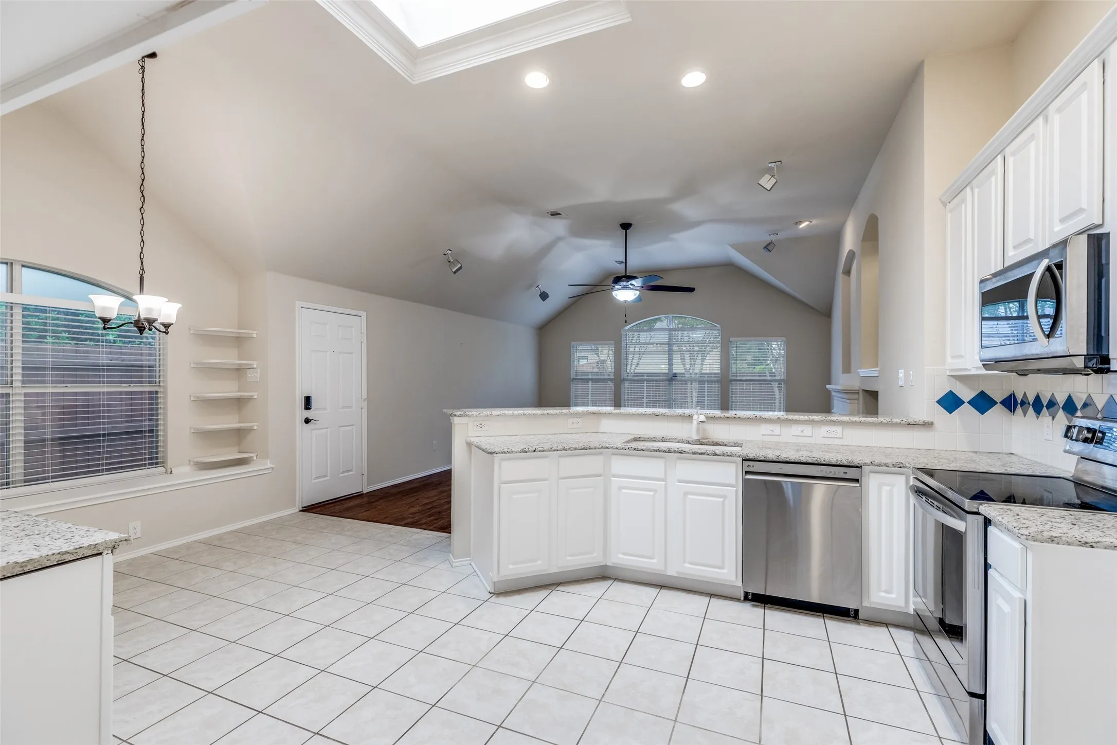Tiled eat-in kitchen lies open to the breakfast area and living area beyond.