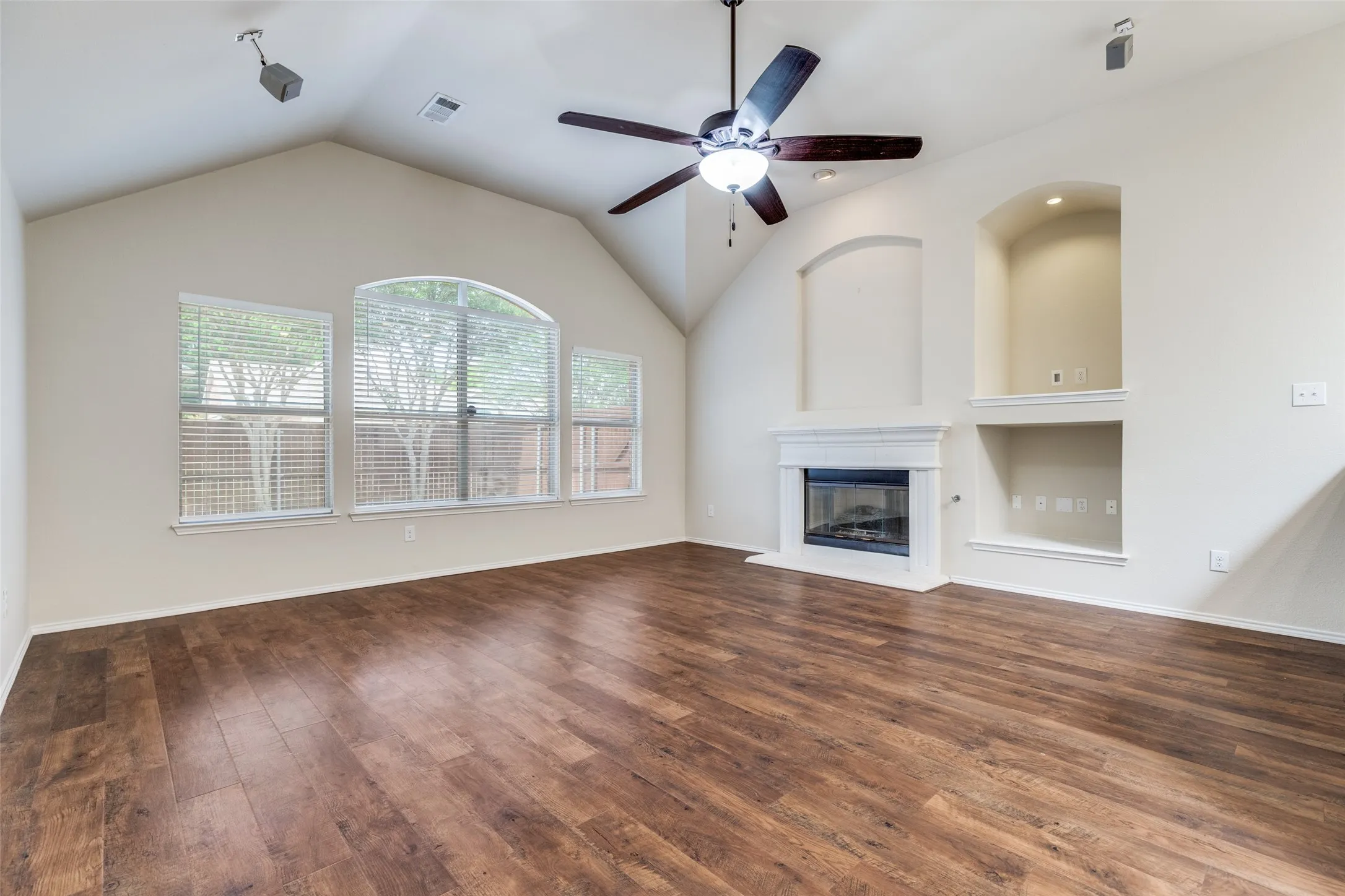 Cast stone fireplace has gas logs and starter.