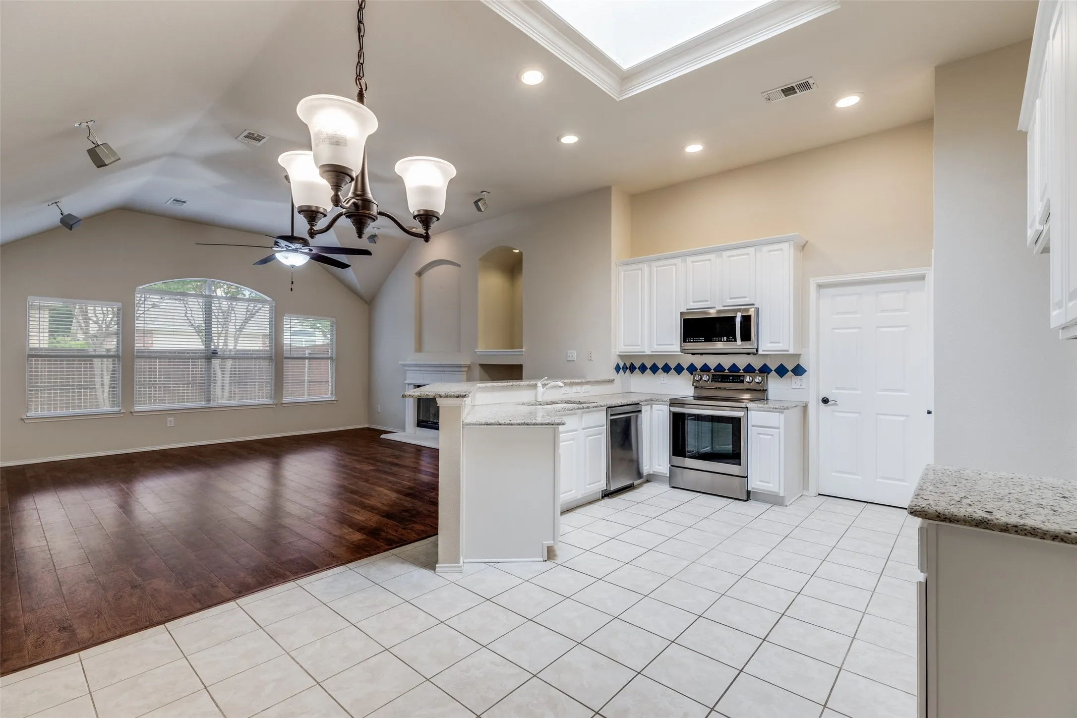 Breakfast bar separates kitchen from primary living area.