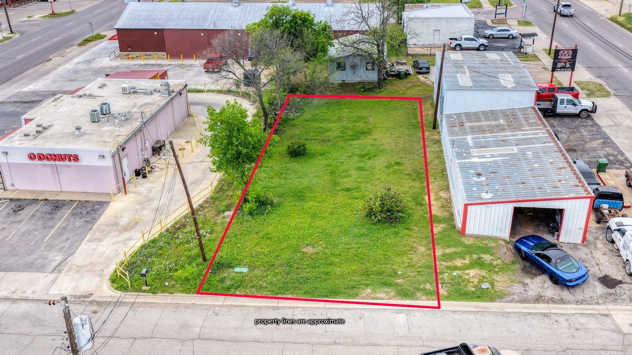This property features a spacious, level lot with a grass lawn, ideal for various development opportunities