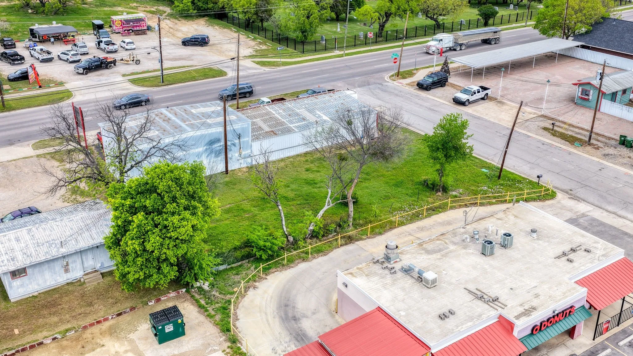 Aerial view showcasing the property's location with direct road frontage and visible access