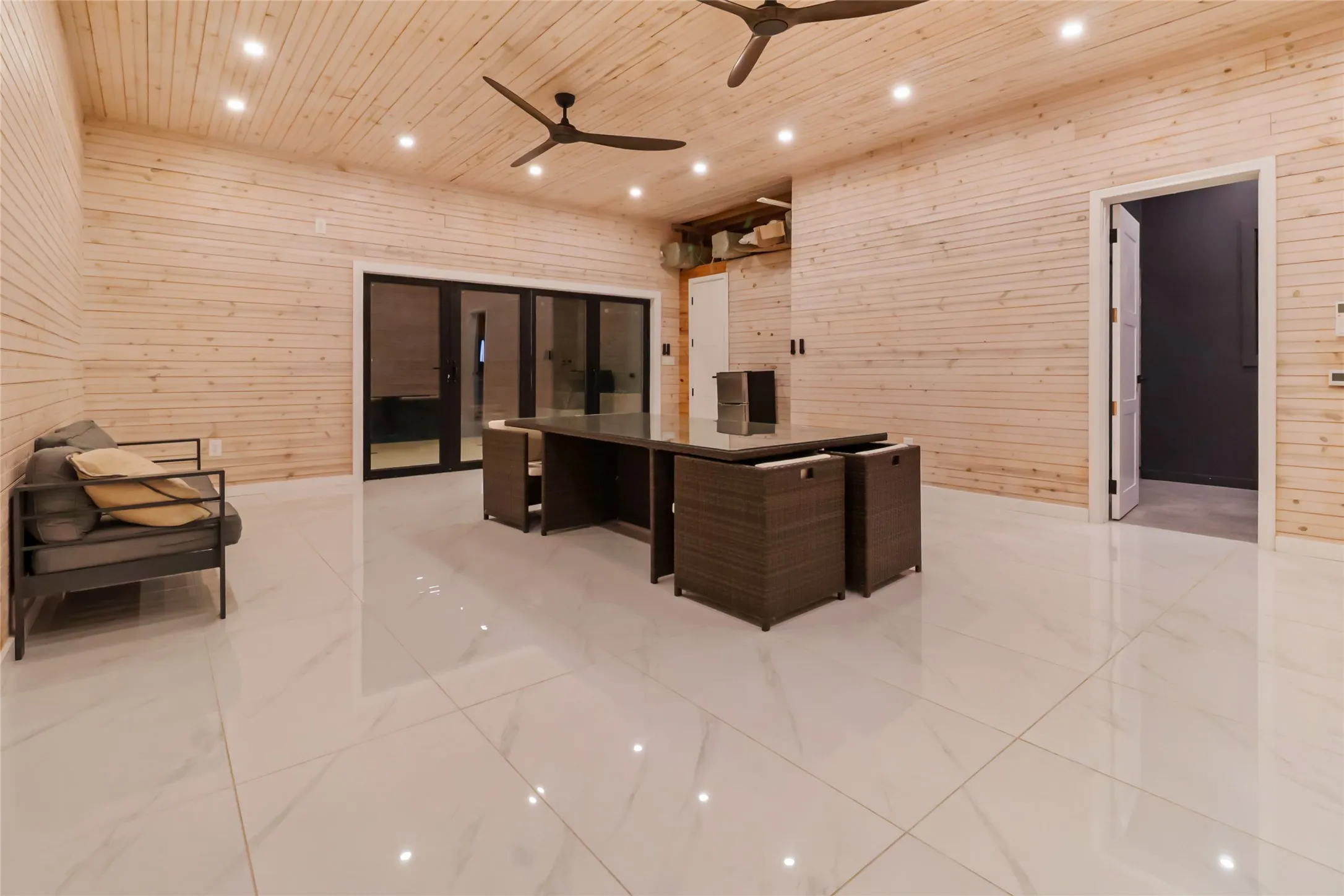 Unfurnished office with wood walls, recessed lighting, wooden ceiling, light marble finish flooring, and ceiling fan
