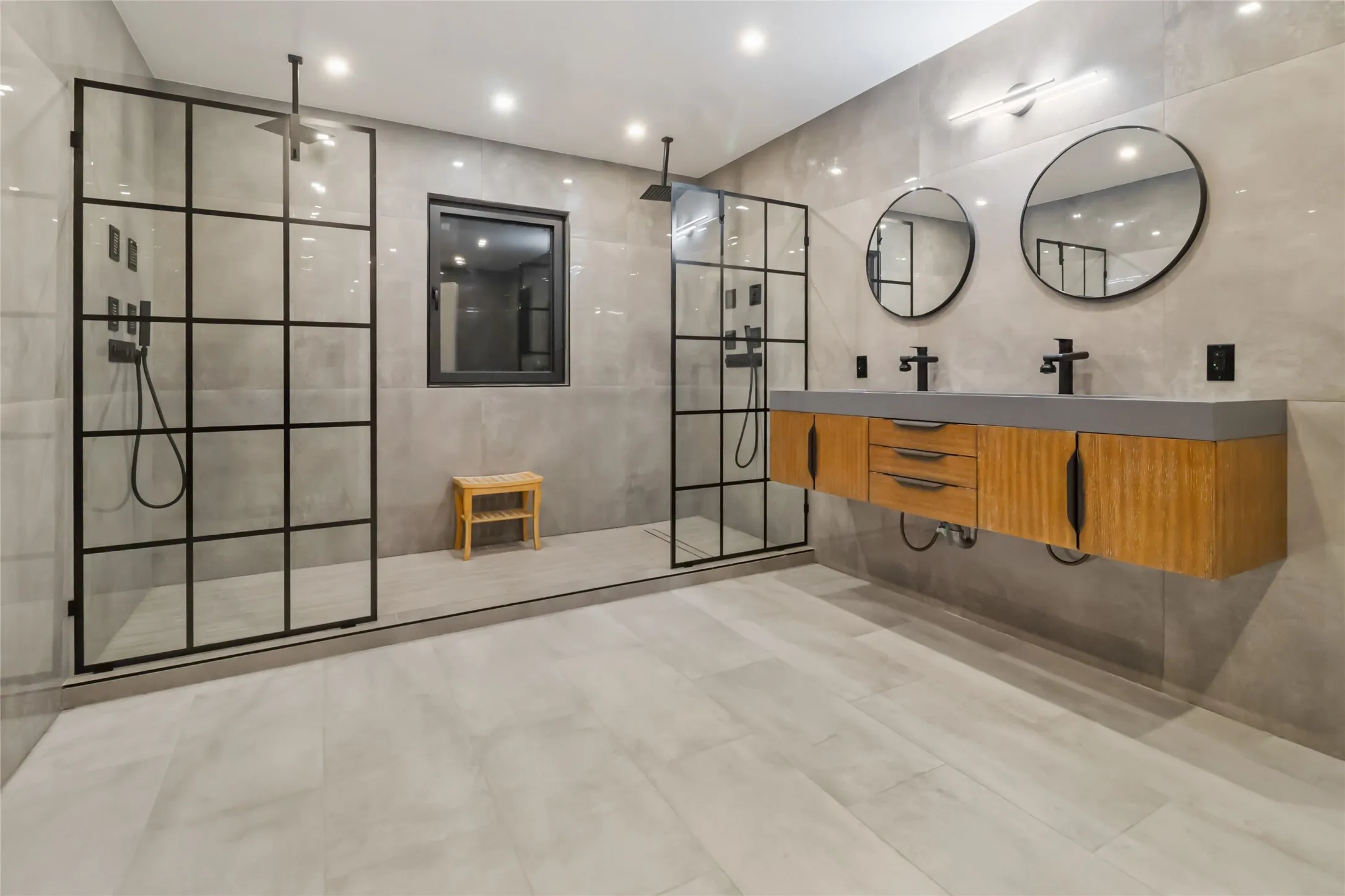 Bathroom with walk in shower, double vanity, recessed lighting, tile walls, and tile patterned flooring