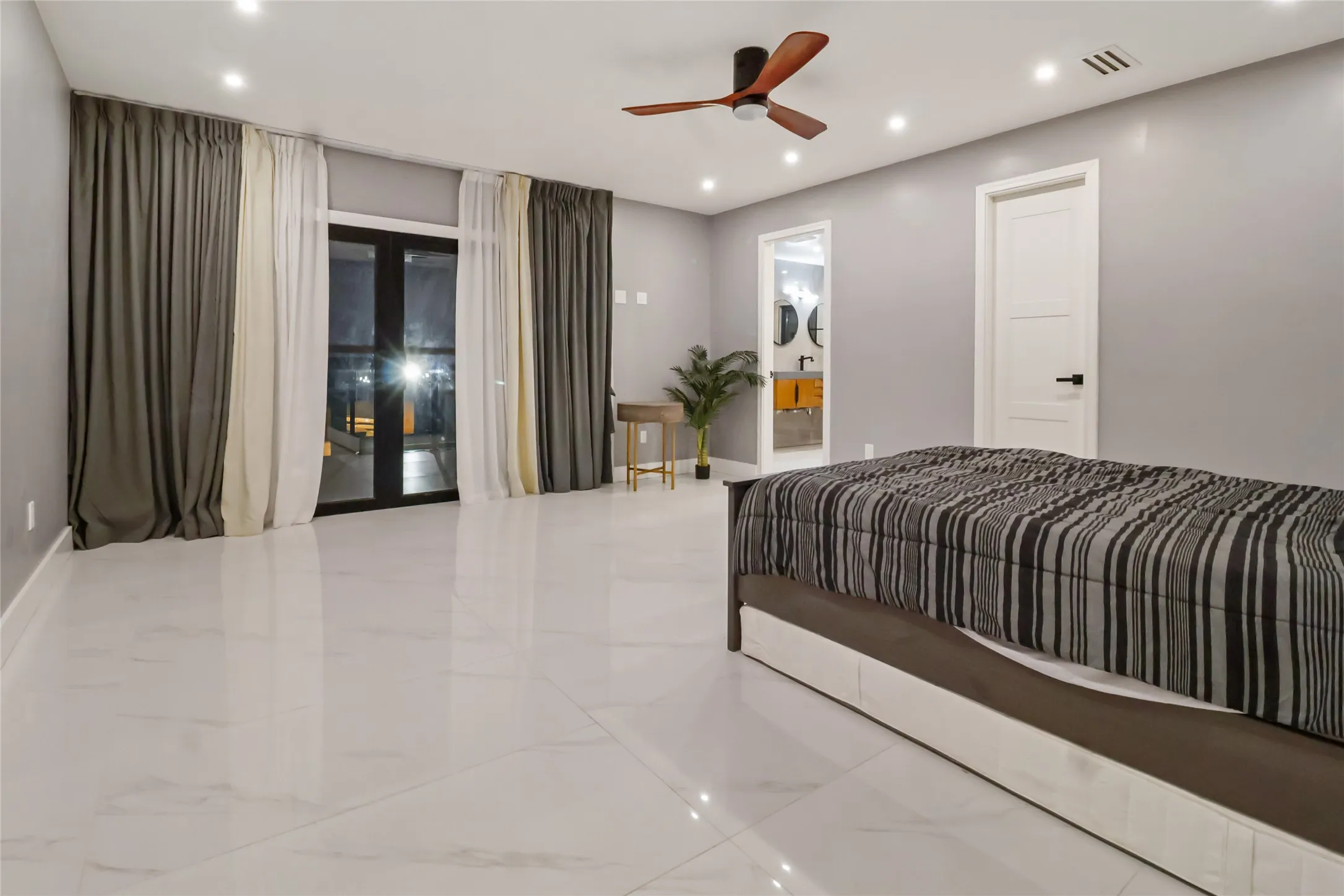 Bedroom with recessed lighting, access to exterior, marble finish floors, connected bathroom, and french doors