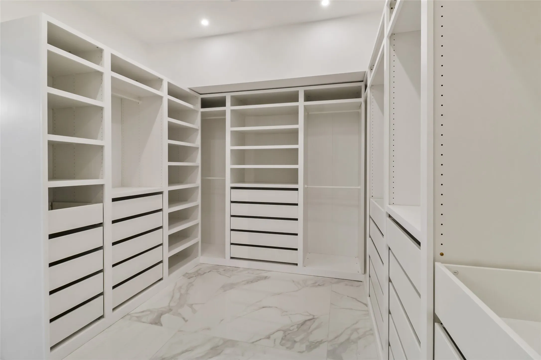 Spacious closet with light marble finish flooring