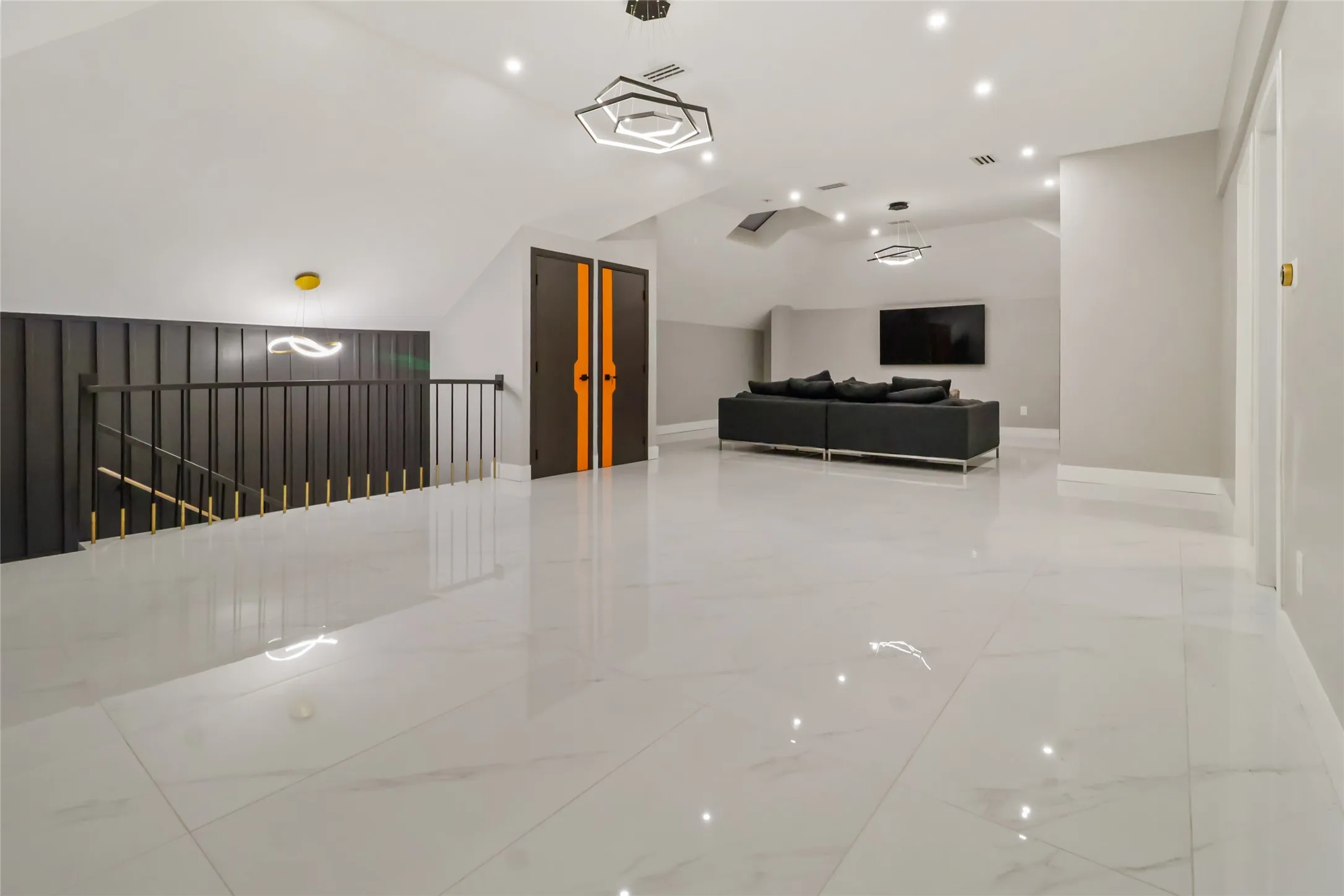 Living area with light marble finish flooring, recessed lighting, and vaulted ceiling