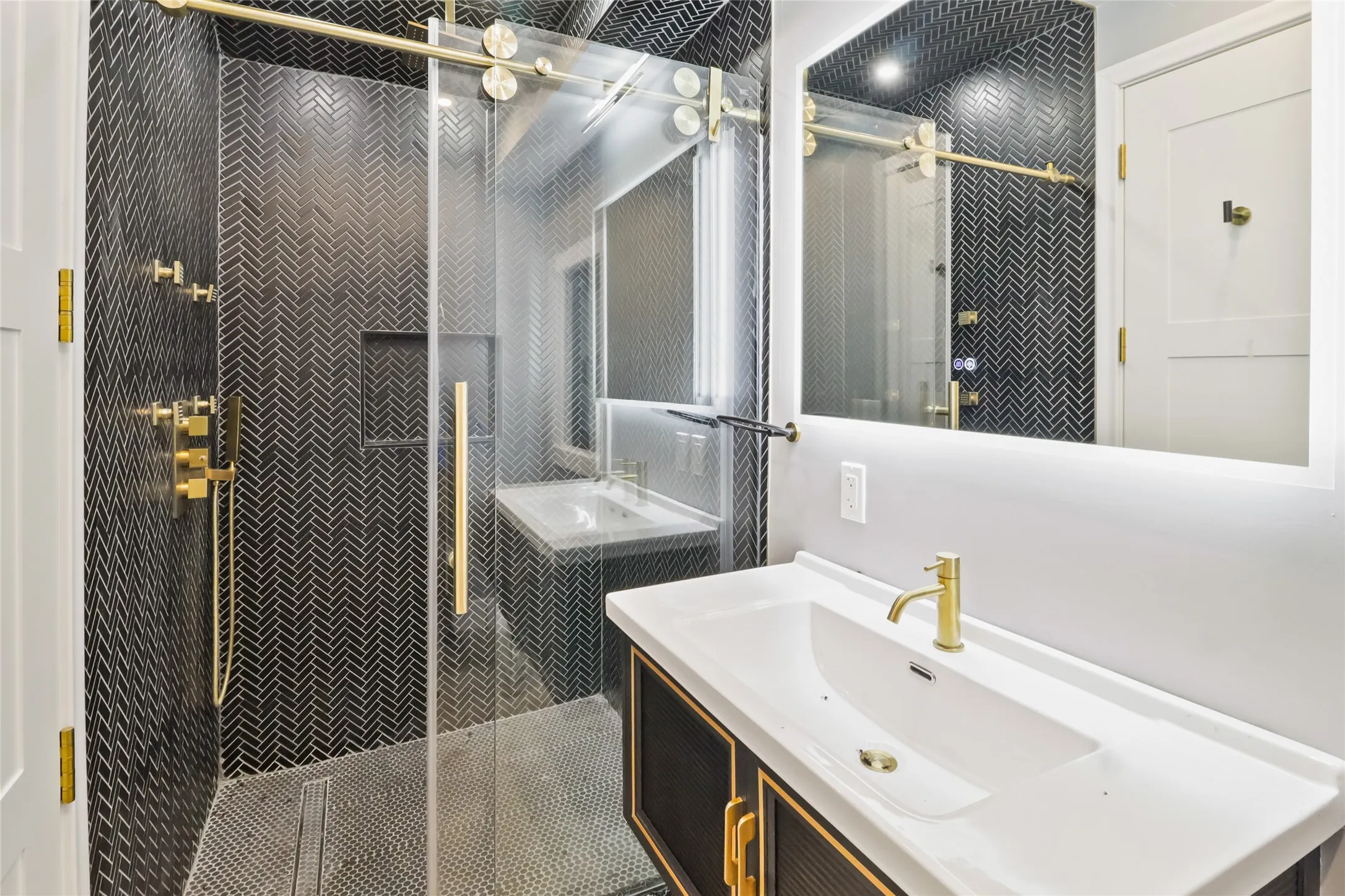 Bathroom with two vanities and a shower stall