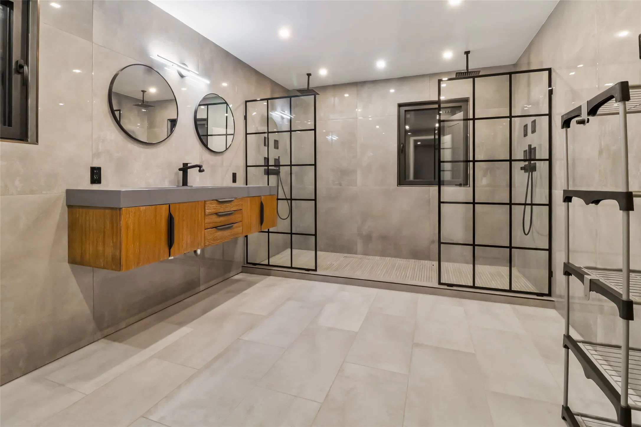 Full bath with tile walls, vanity, a walk in shower, recessed lighting, and tile patterned flooring