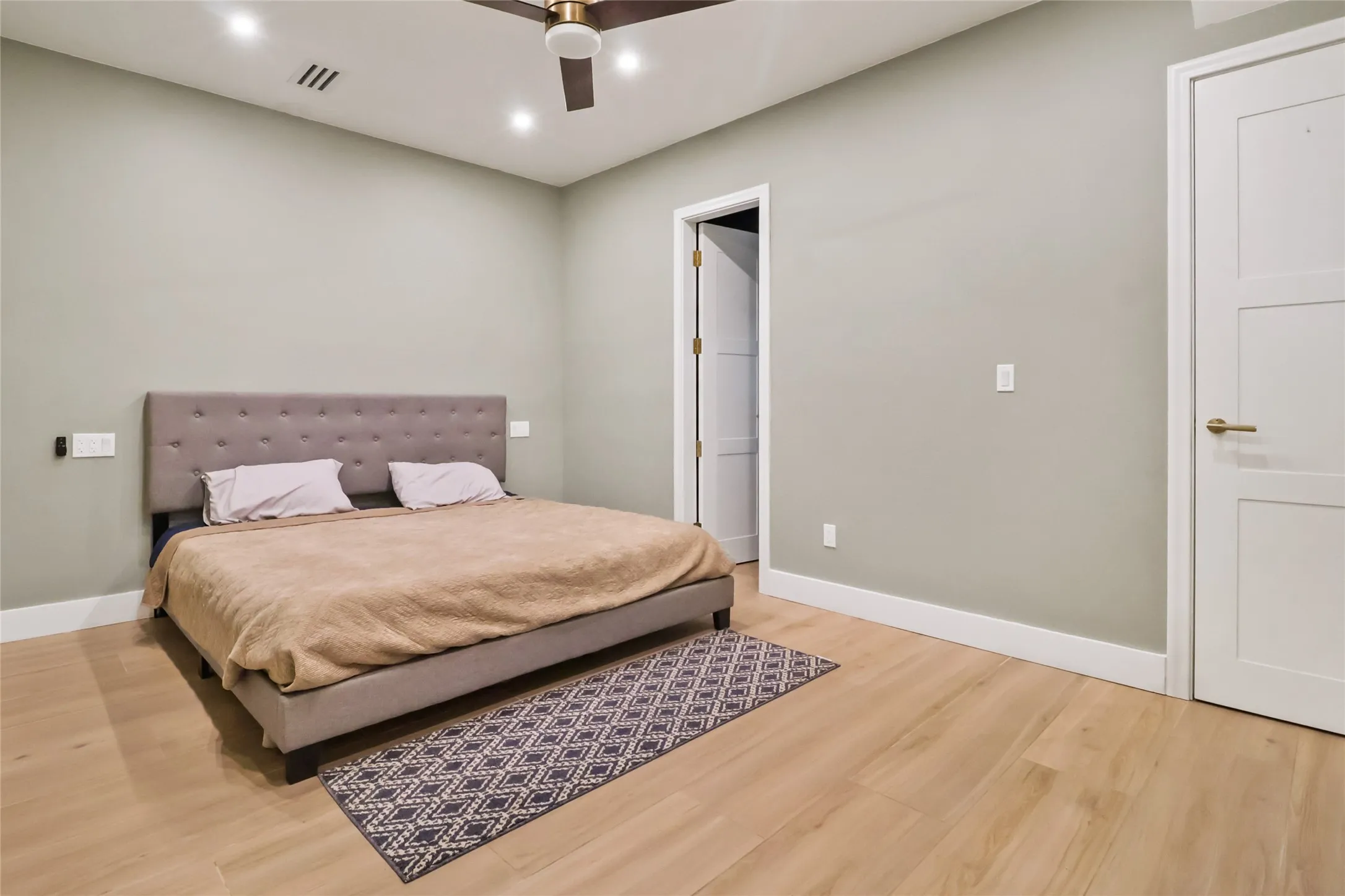 Bedroom featuring light wood finished floors, a ceiling fan, and recessed lighting