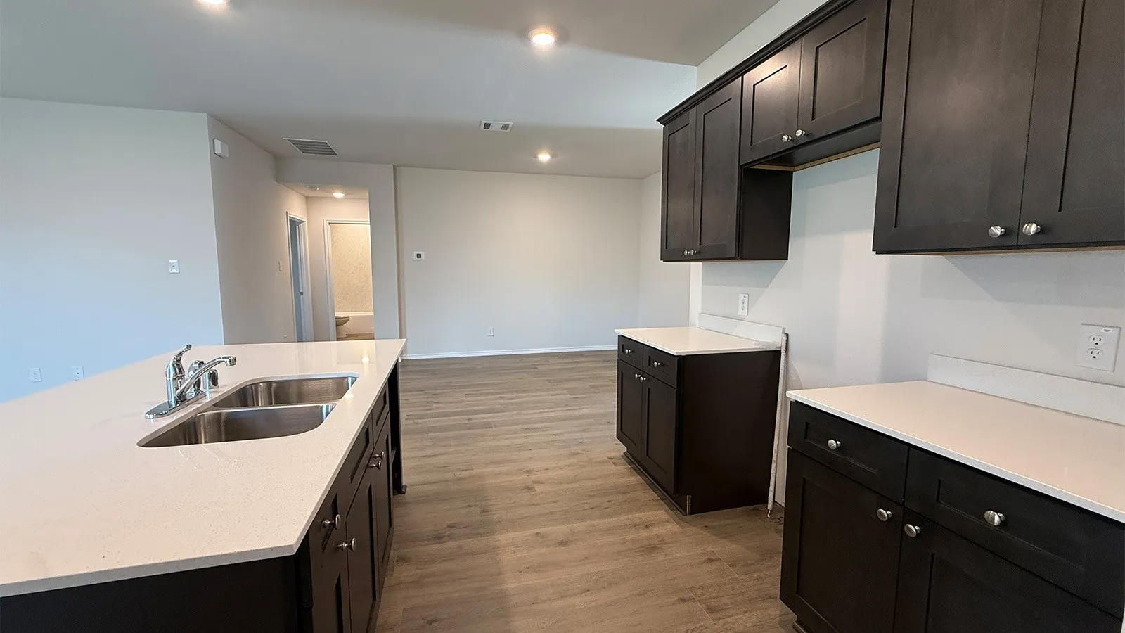 Kitchen island with a double basin stainless steel sink and white countertop