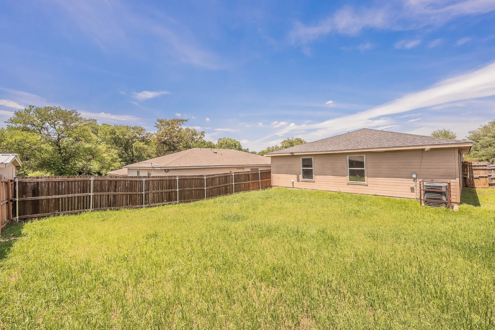Expansive backyard with a wooden privacy fence