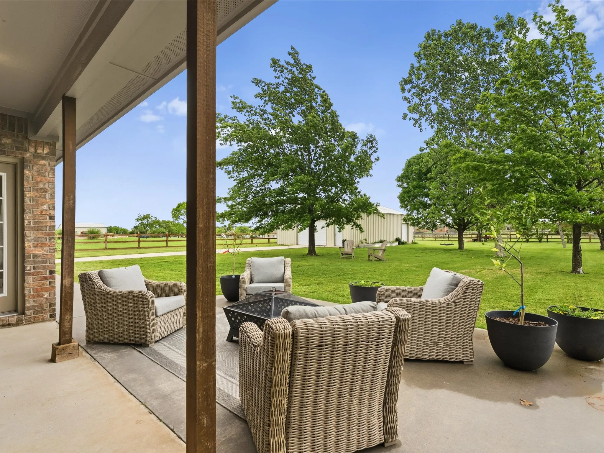 The property features a covered patio with a concrete surface, providing a perfect outdoor living space