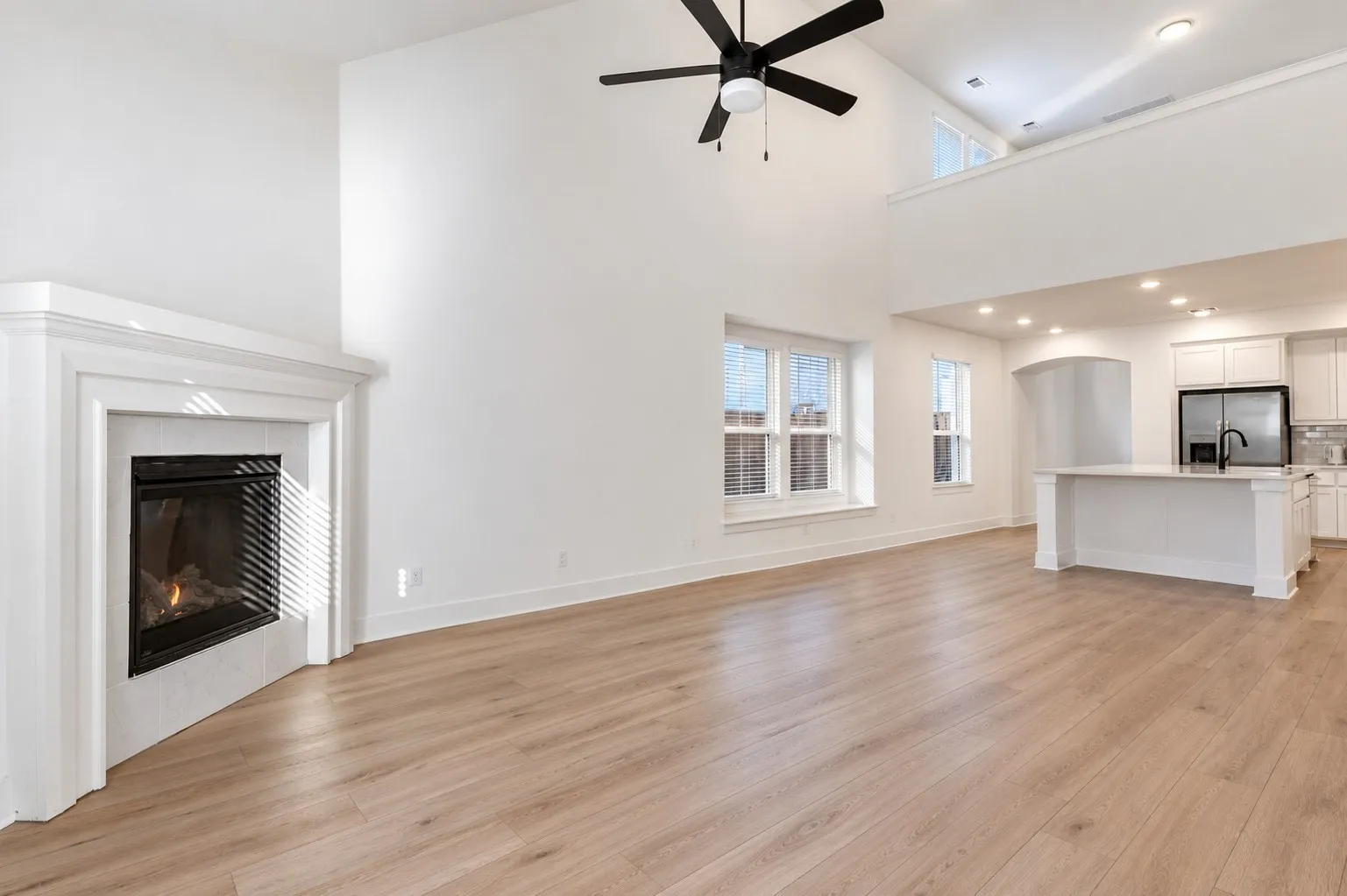 The Lofty, Airy Open-Concept Main Living Space is Centered by a Gas Log Fireplace.