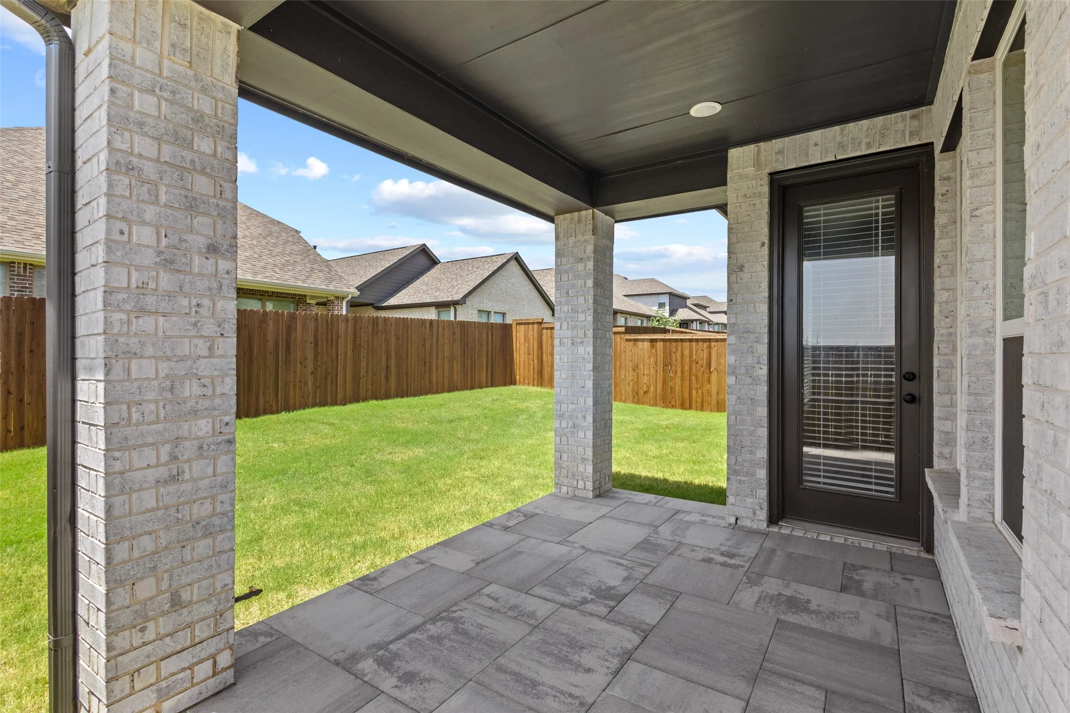 The Covered Patio with Patterned Concrete and Gas Grill Connection.
