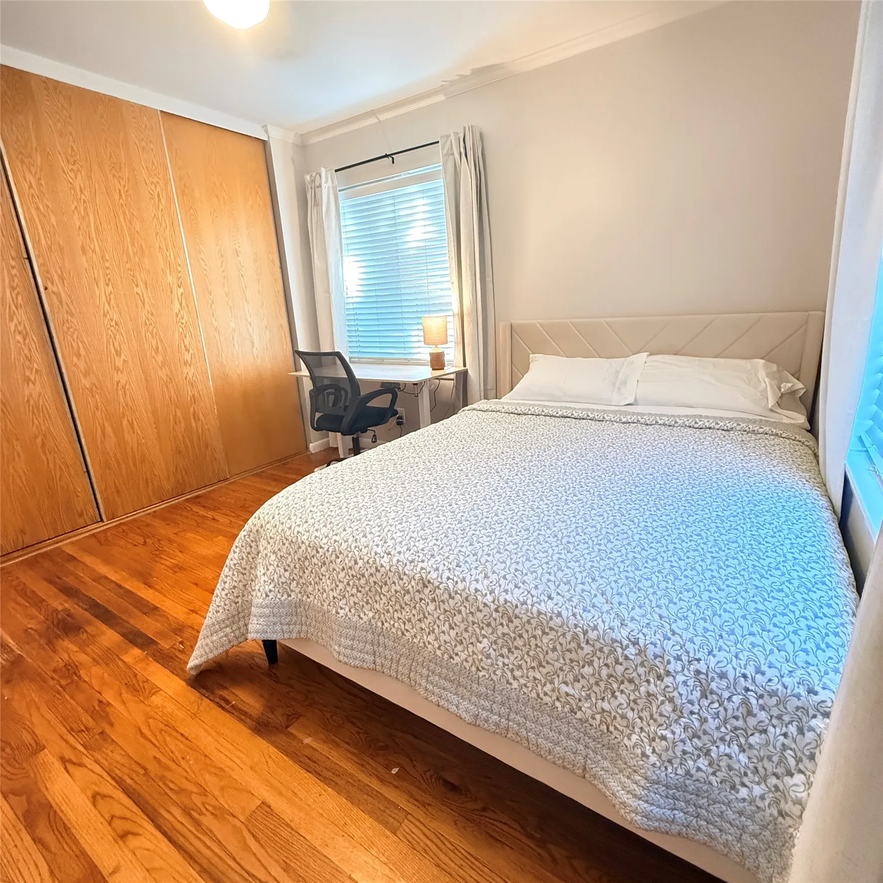 This room features polished hardwood flooring and light-colored walls