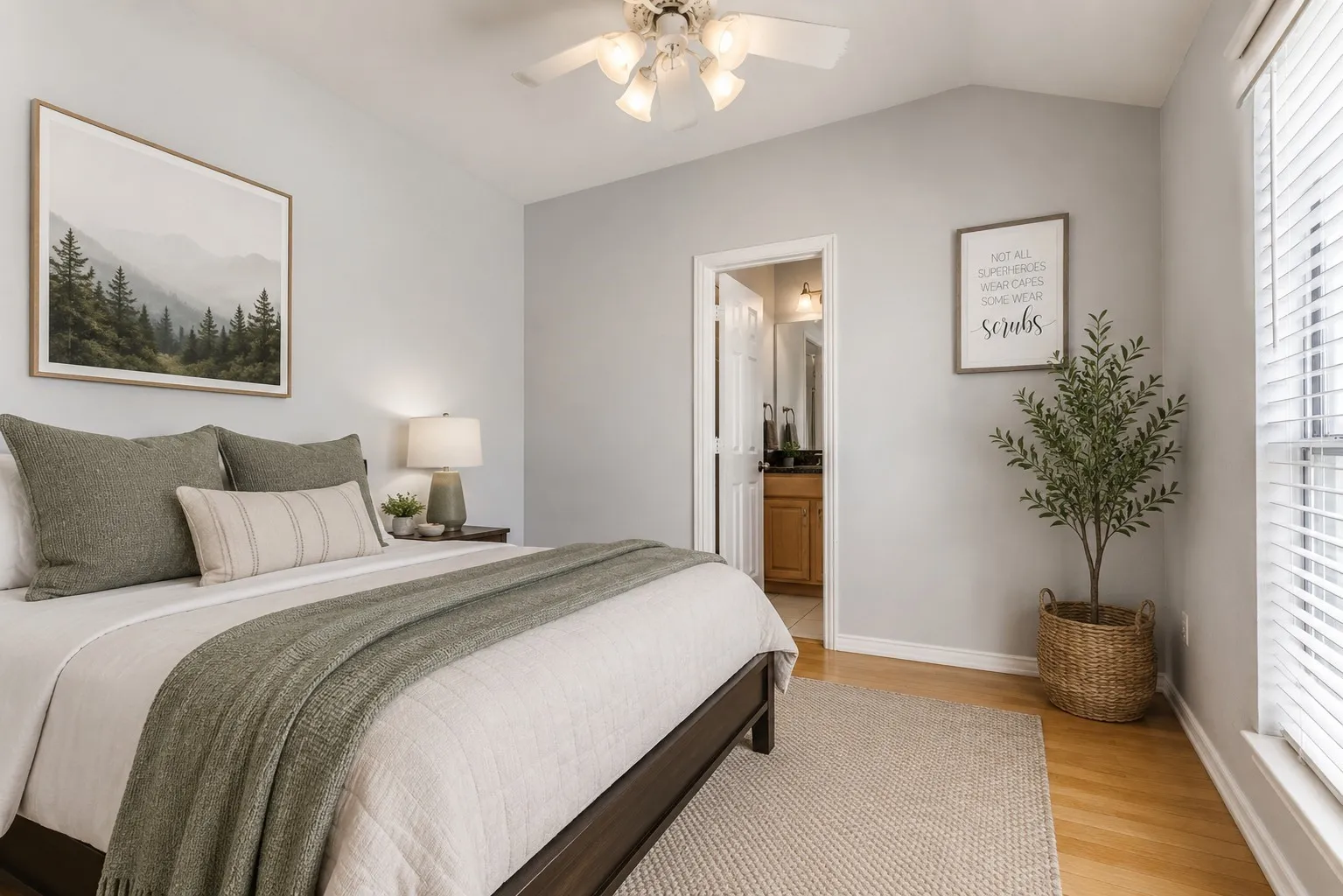 Bedroom featuring vaulted ceilings, wood-finish flooring, a ceiling fan with integrated lighting, and white window blinds