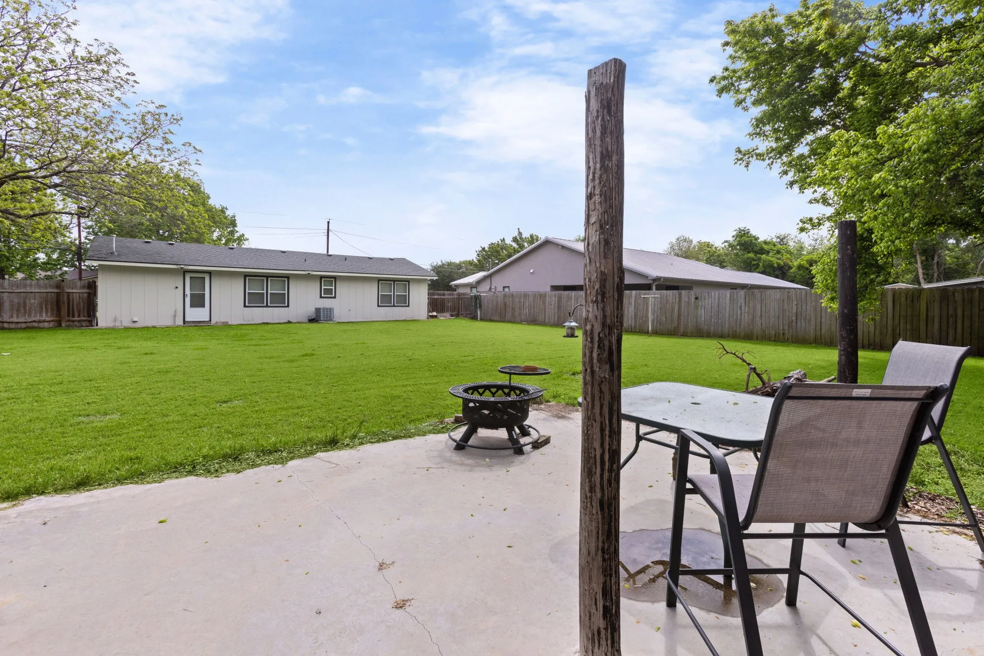 Fenced backyard featuring a patio and an outdoor fire pit
