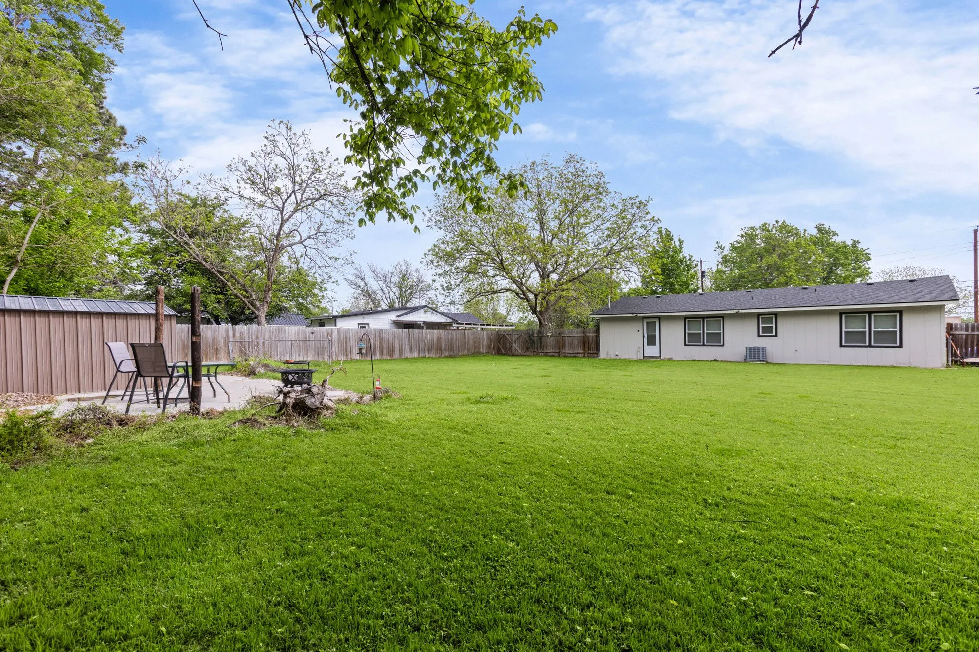 Fenced backyard featuring a patio