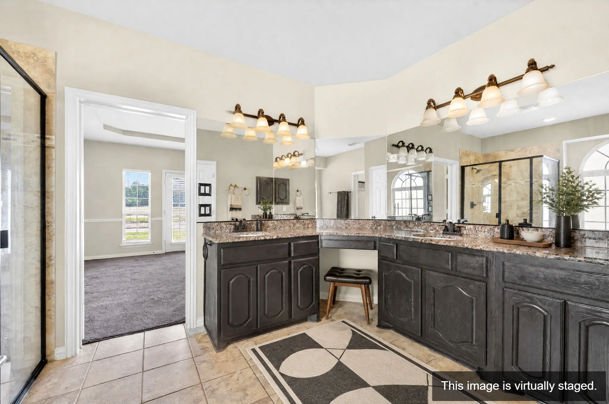 Dual vanity with dark wood-finish cabinetry and stone countertops