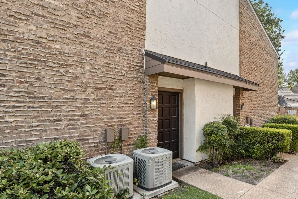 View of exterior entry with stucco siding and brick siding