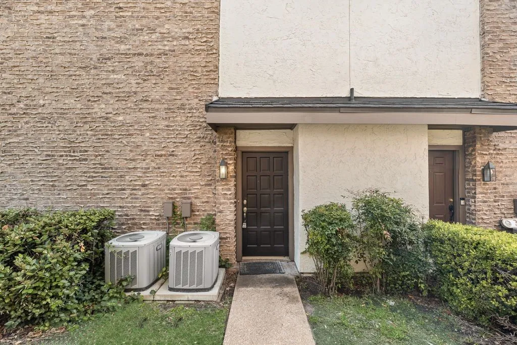 View of exterior entry featuring stucco siding