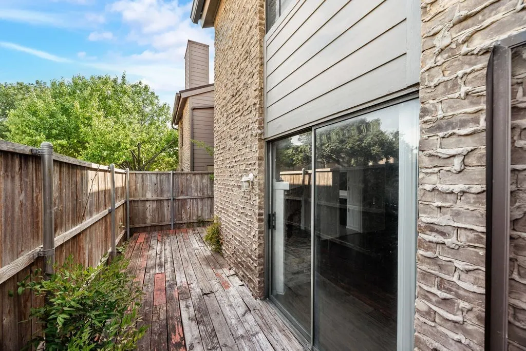Wooden deck featuring a fenced backyard