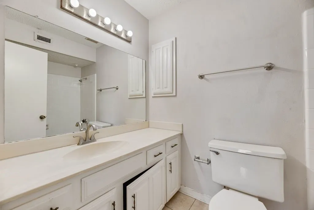 Full bath featuring vanity, tile patterned floors, and a shower