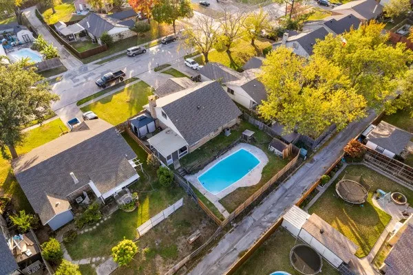 View of property location with a pool and nearby suburban area