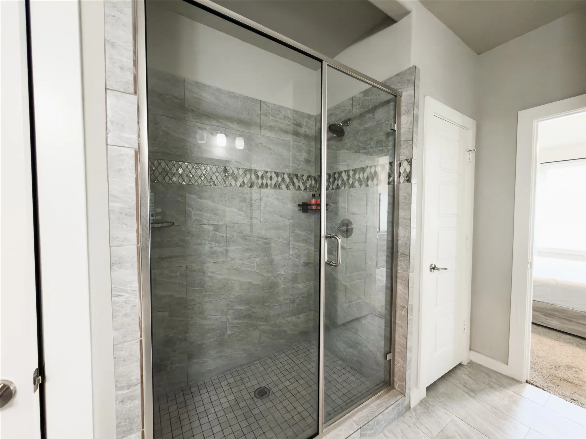 Bathroom with connected bathroom and a shower stall