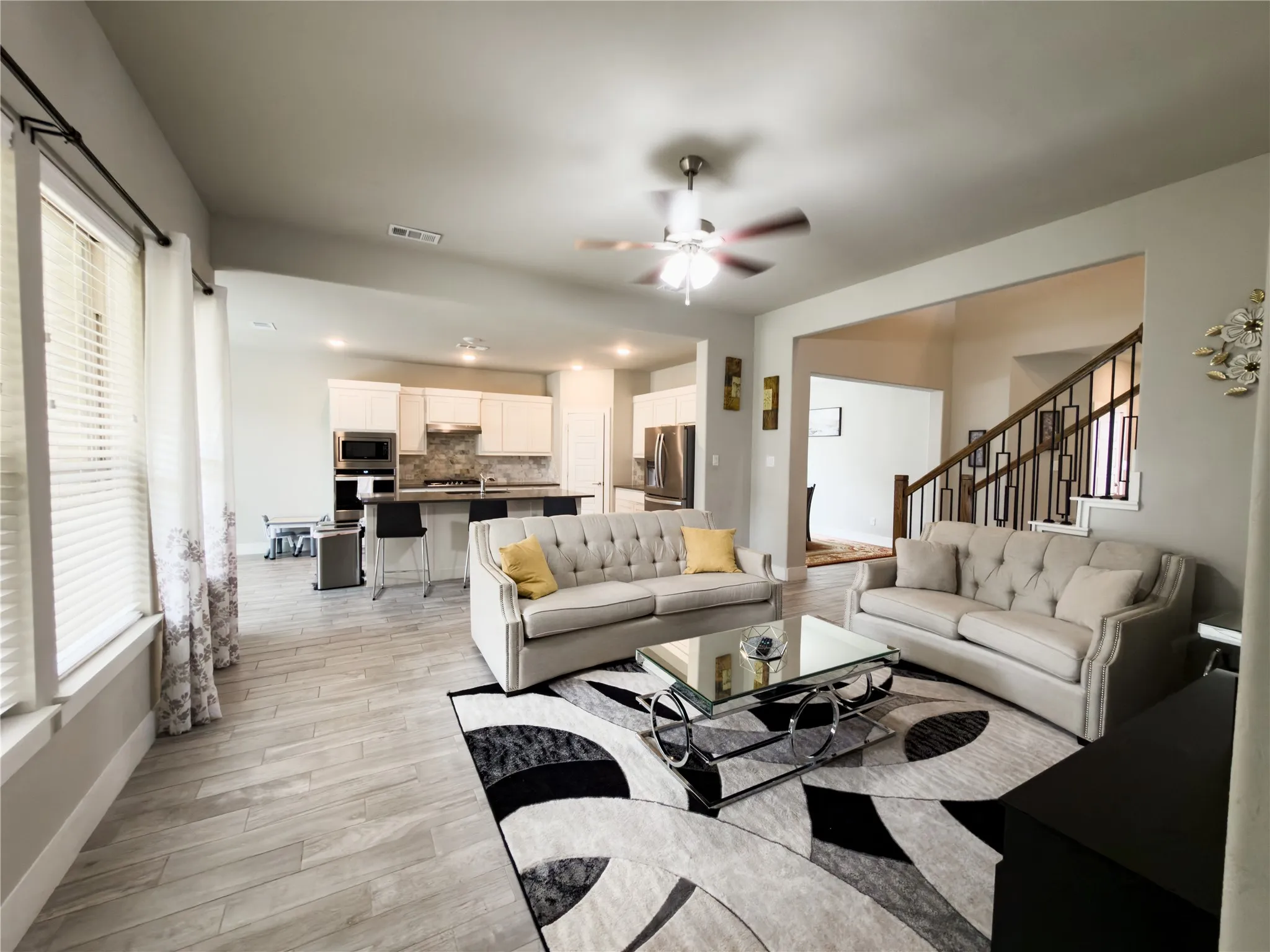 Living room featuring light wood-style floors and ceiling fan