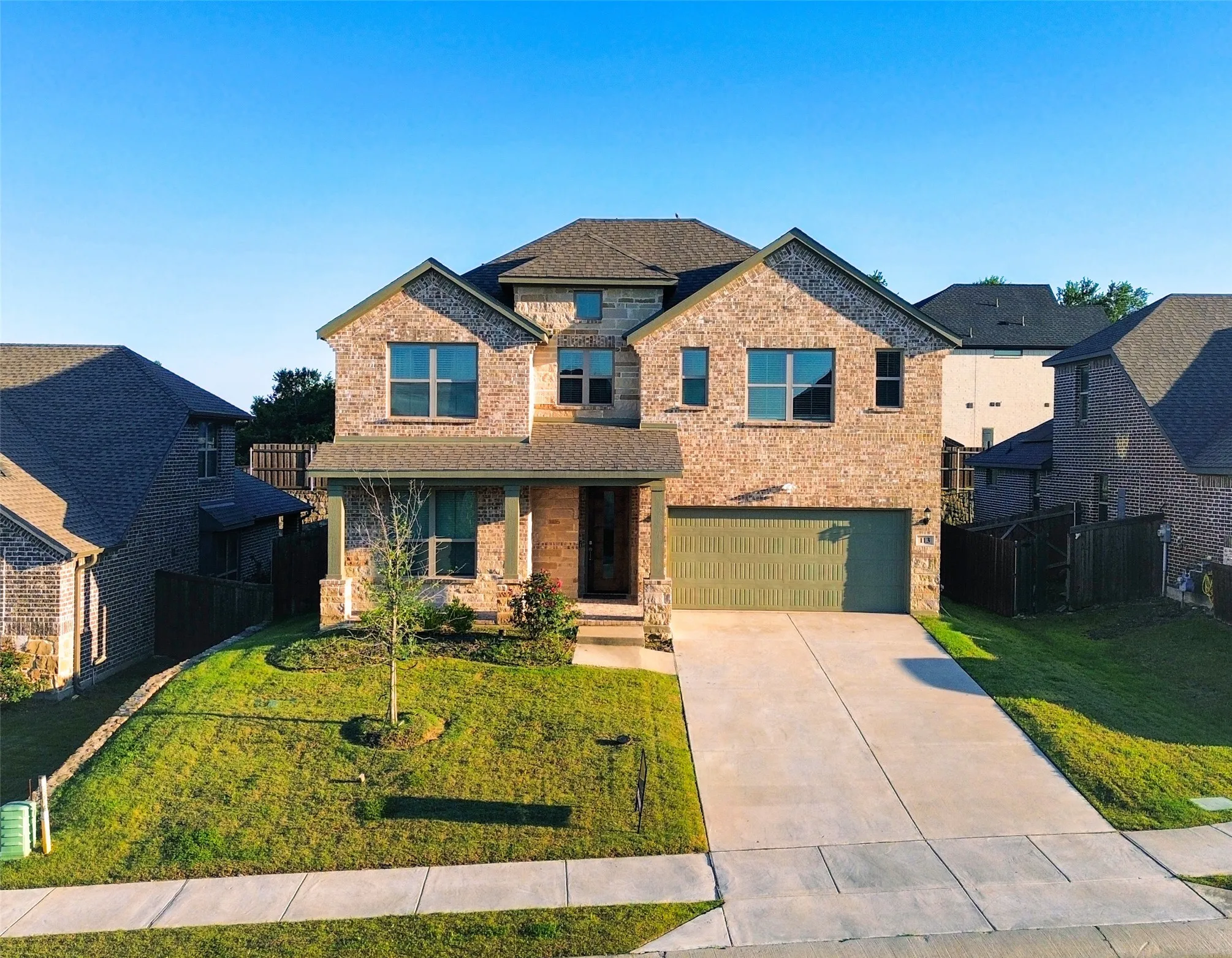 Two-story brick facade residence with a prominent gabled roofline