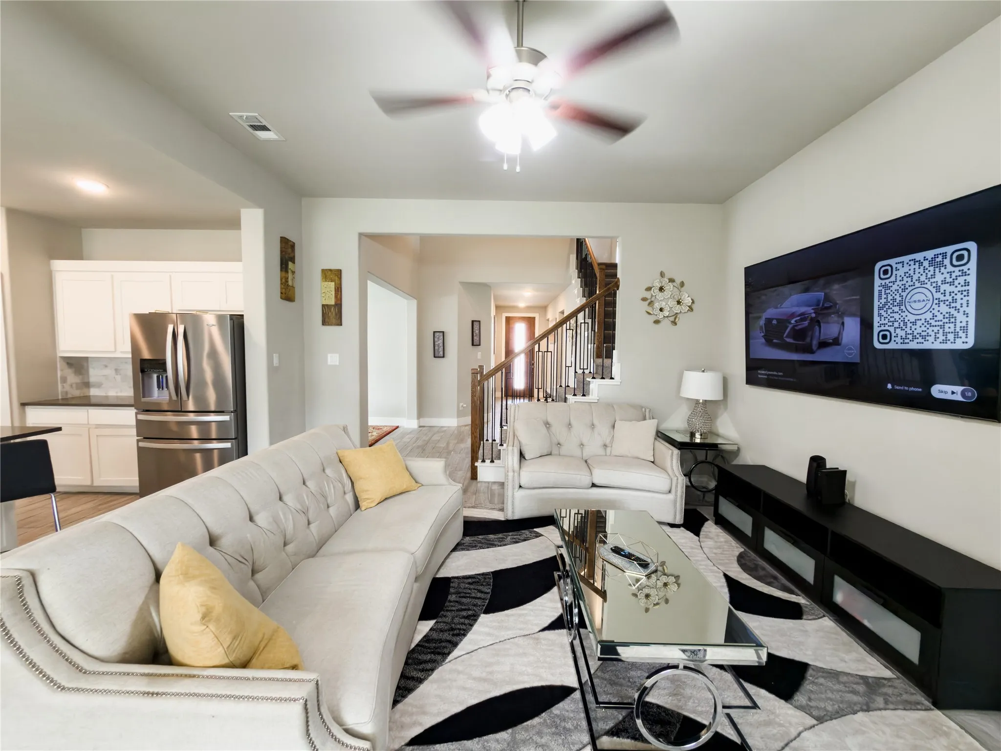 Living area featuring stairway and a ceiling fan