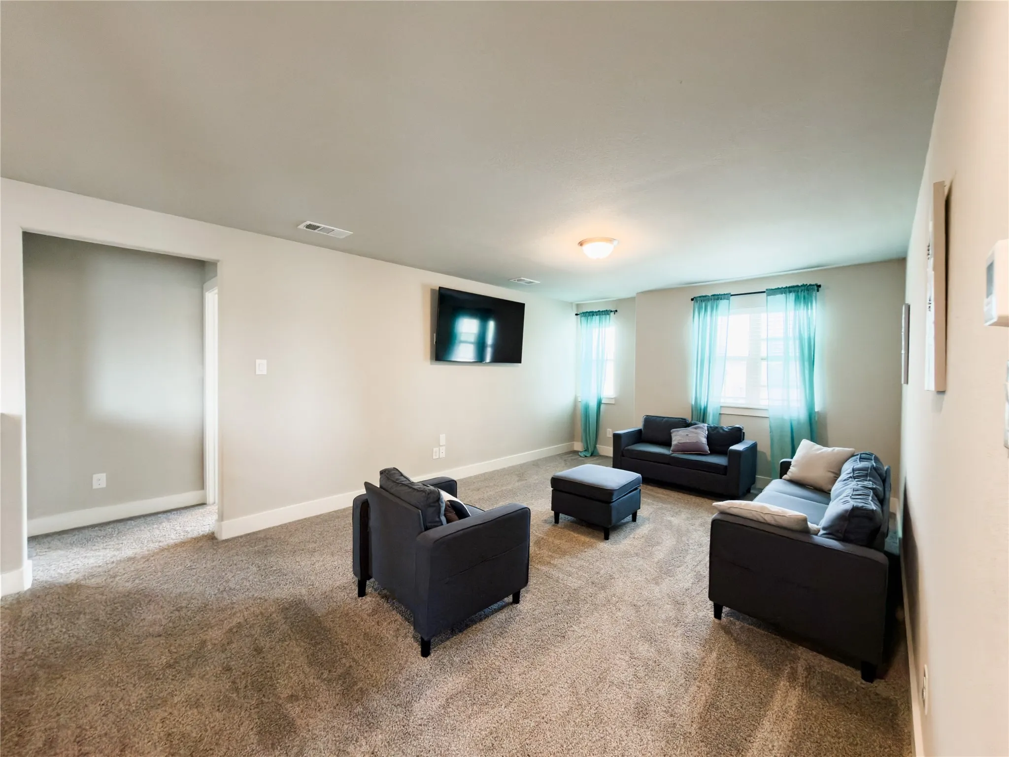 Carpeted living room with baseboards