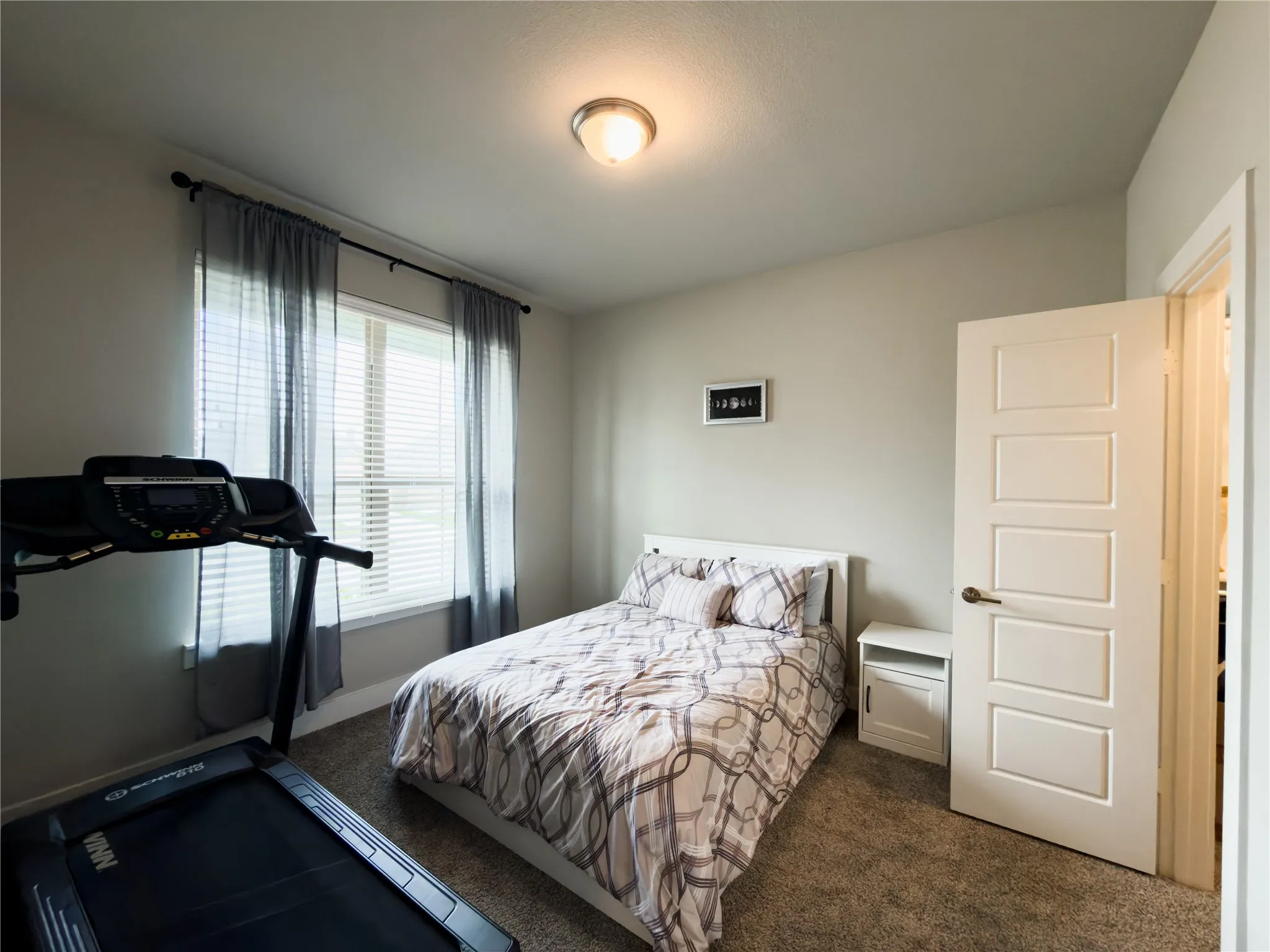 Bedroom featuring dark carpet and baseboards