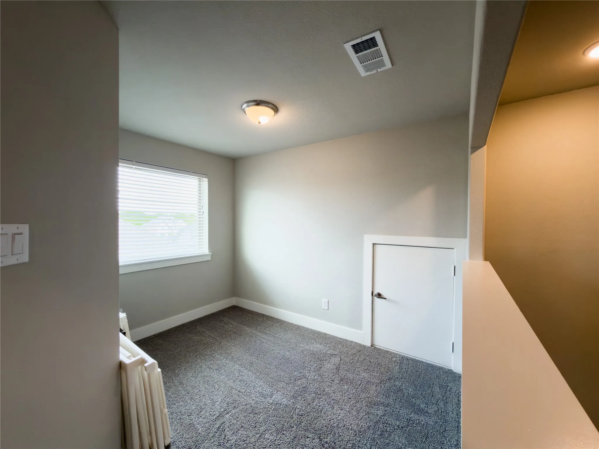 Unfurnished room featuring carpet and baseboards
