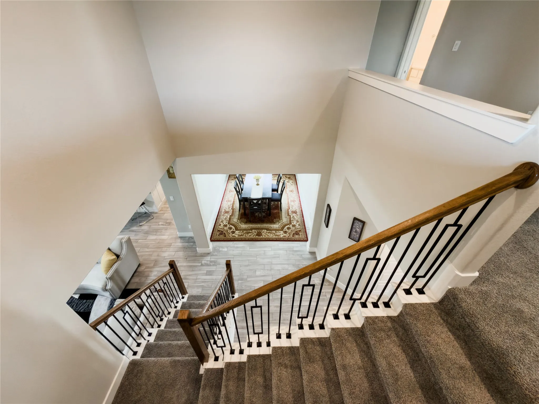 Stairs with carpet floors and a high ceiling