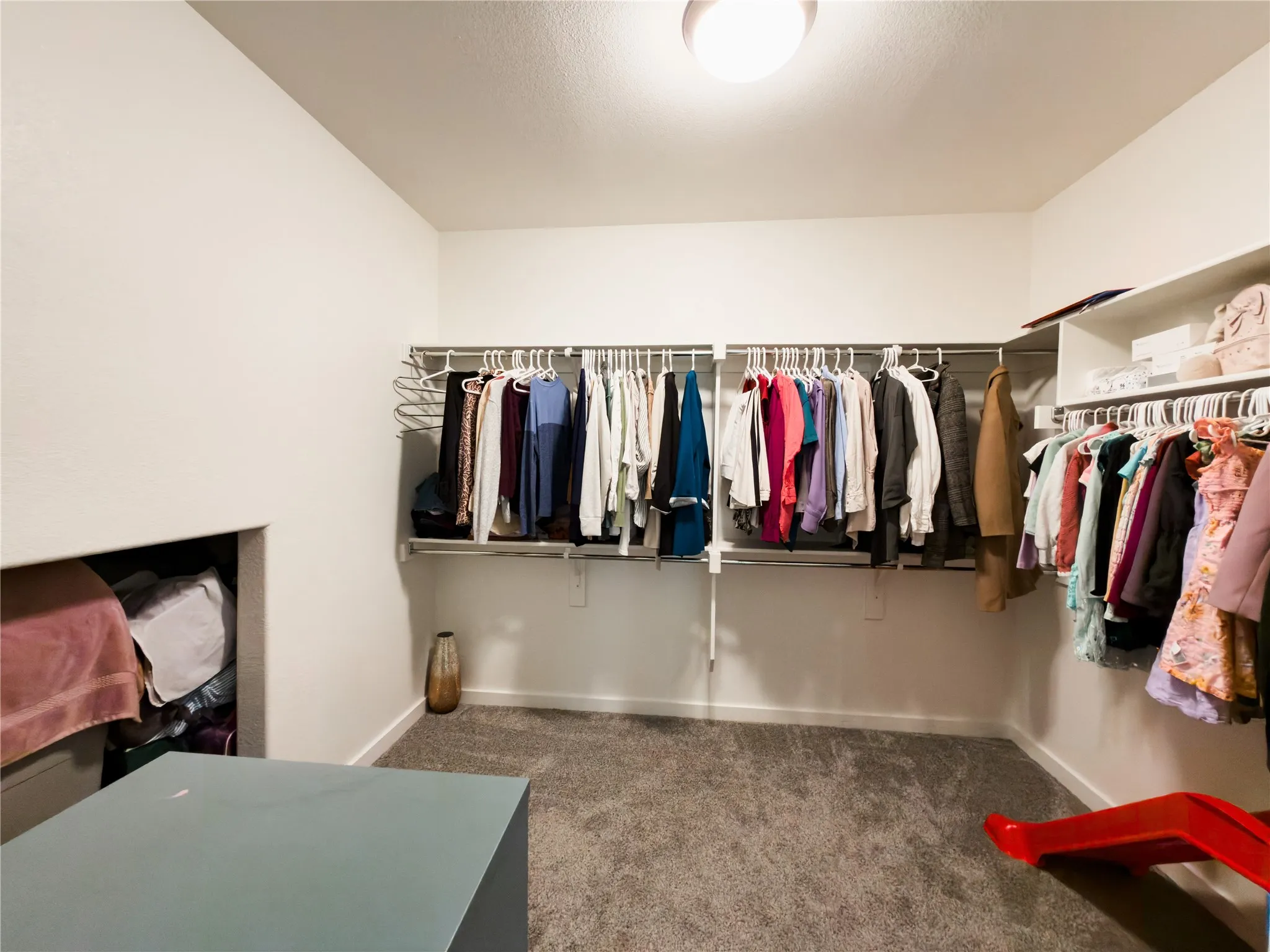 Walk in closet featuring dark carpet