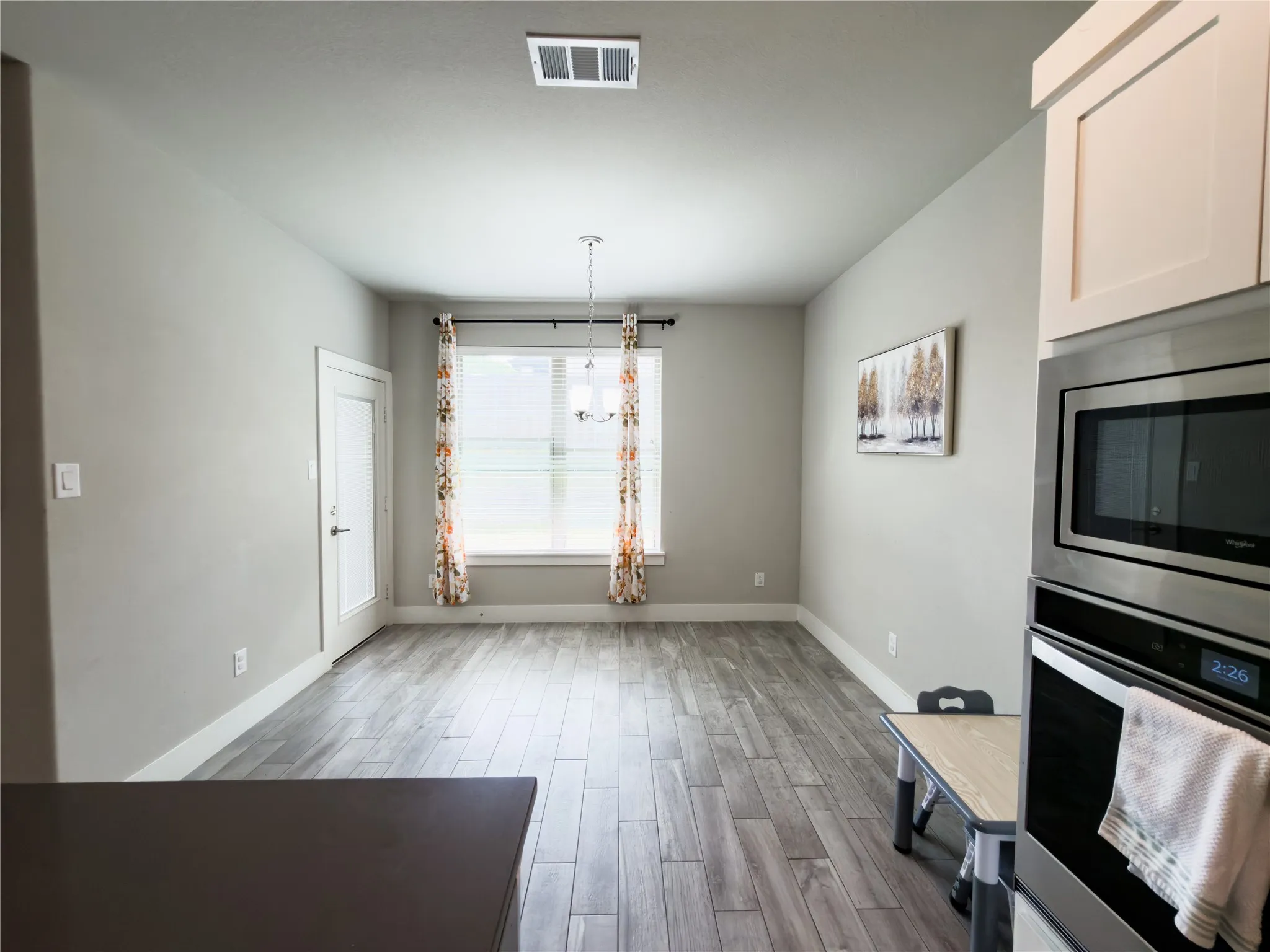 Unfurnished breakfast area featuring wood tiled floors and baseboards