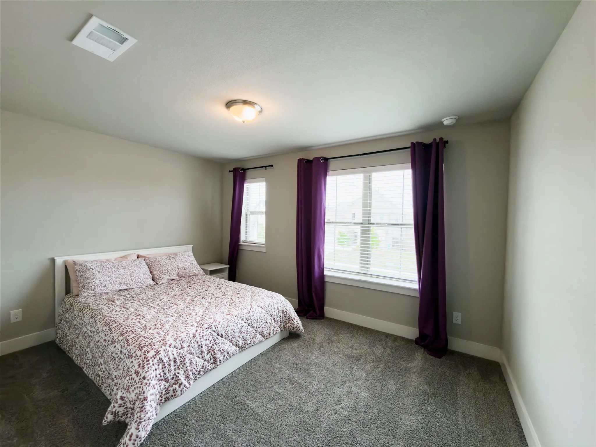 Carpeted bedroom featuring baseboards