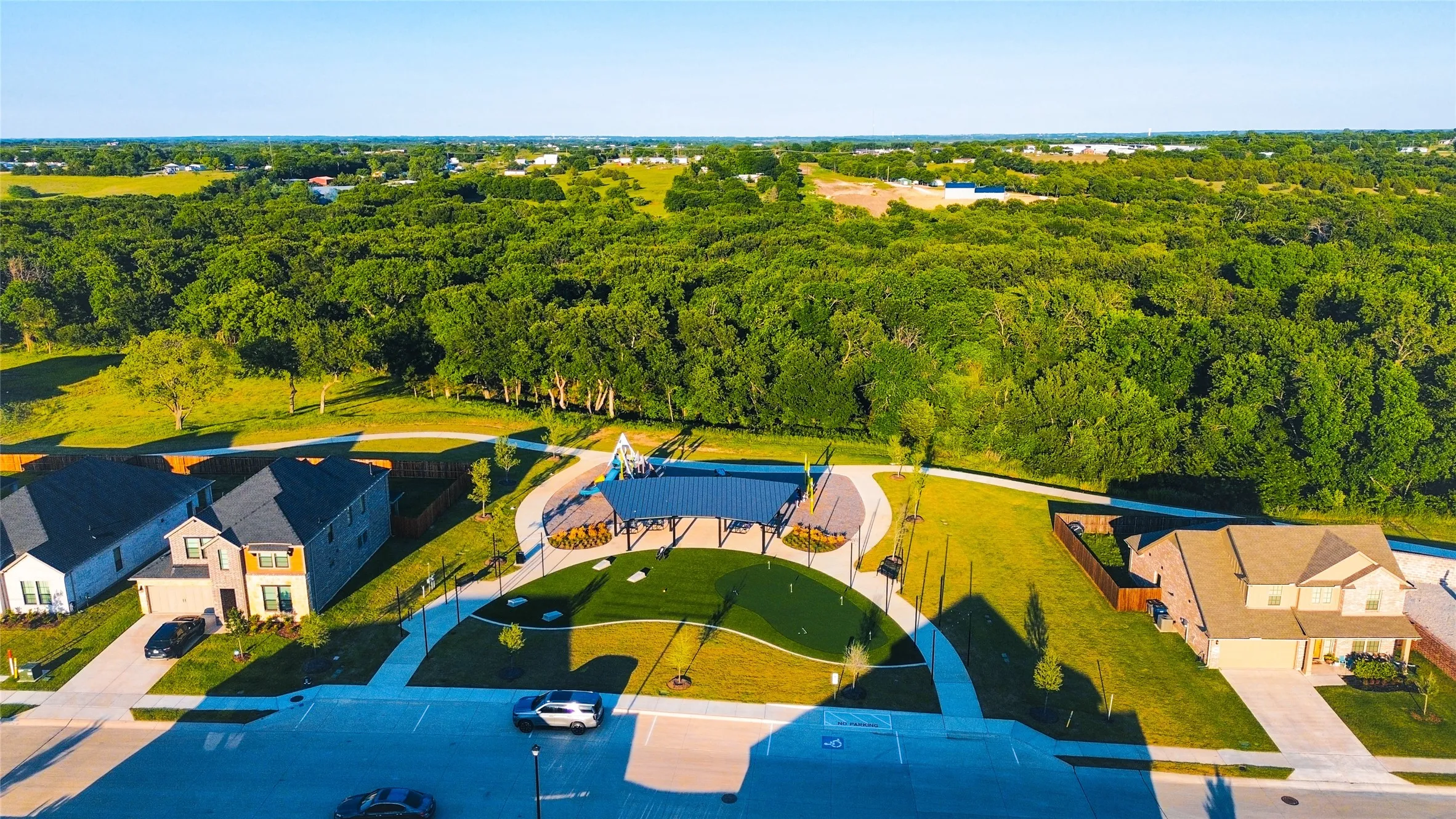 Community park with covered seating area and turf play surface