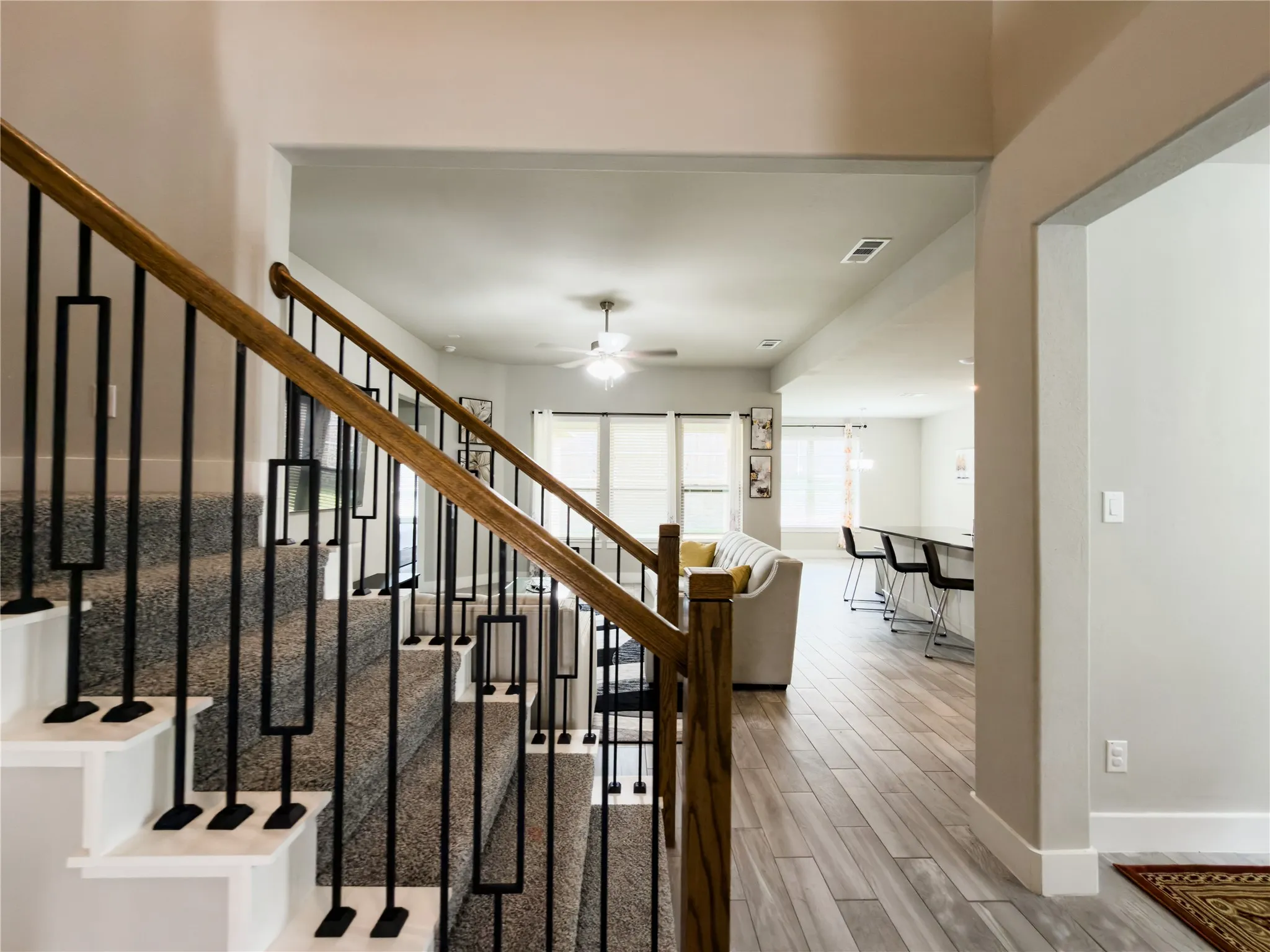 Stairway featuring ceiling fan and wood finish floors