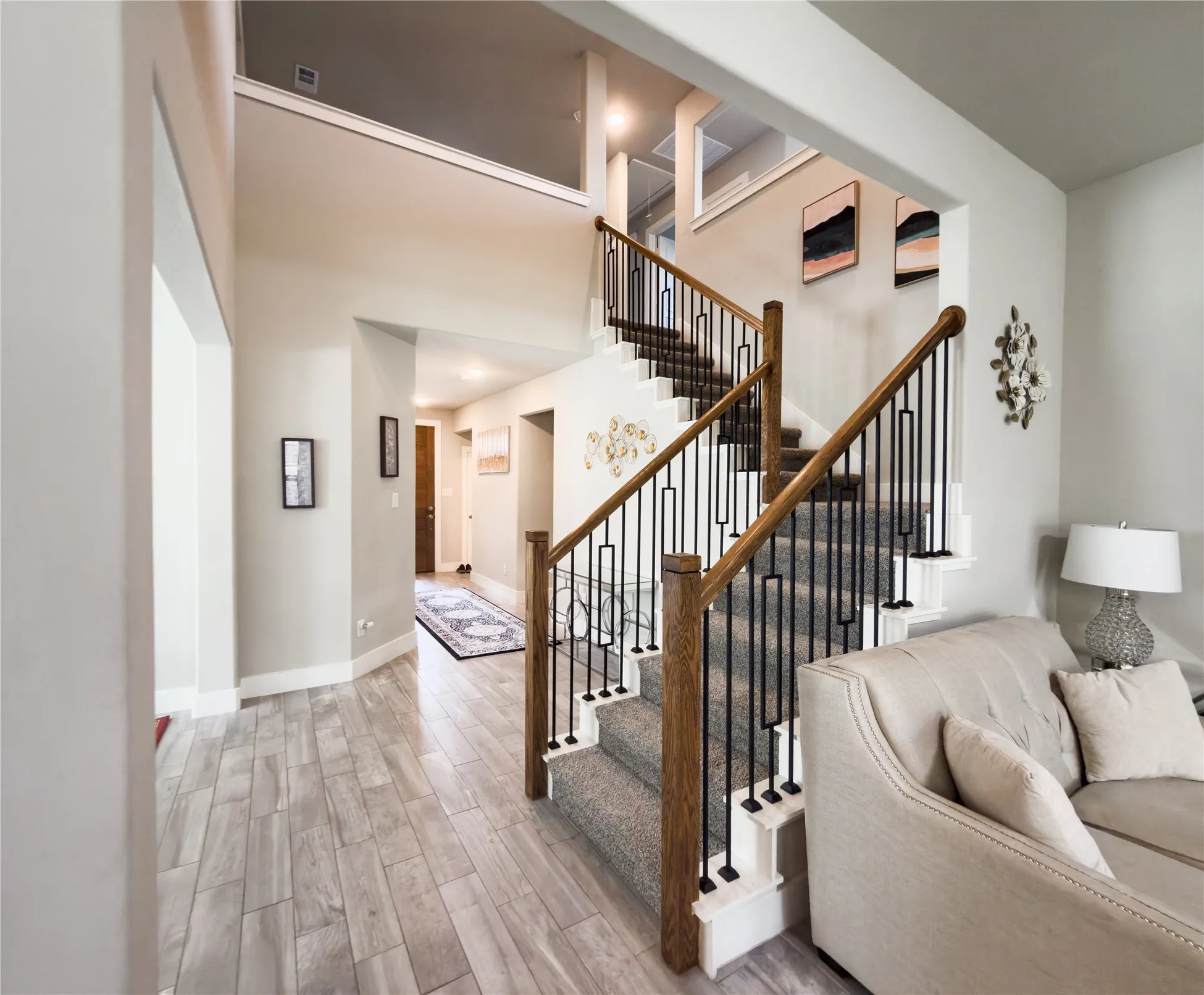 Staircase featuring wood tiled floors and a high ceiling
