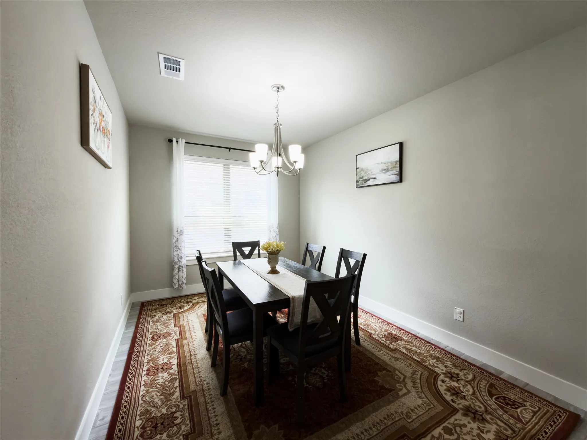 Dining room with baseboards and hanging lights