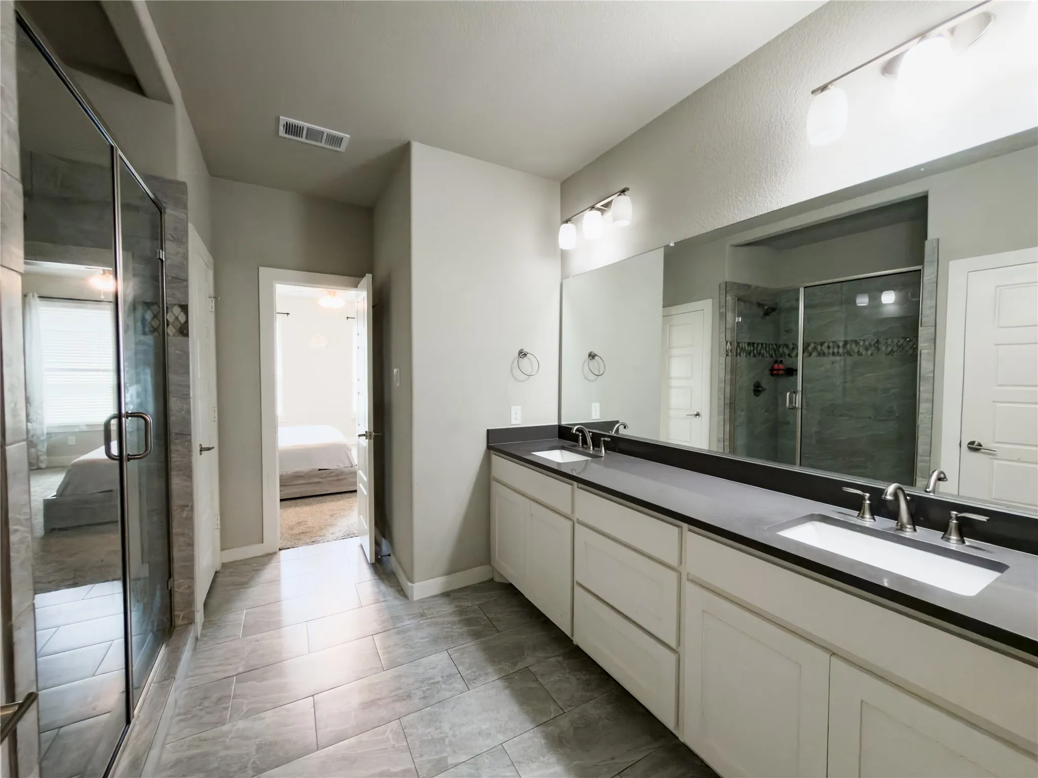 Ensuite bathroom with double vanity and a shower stall
