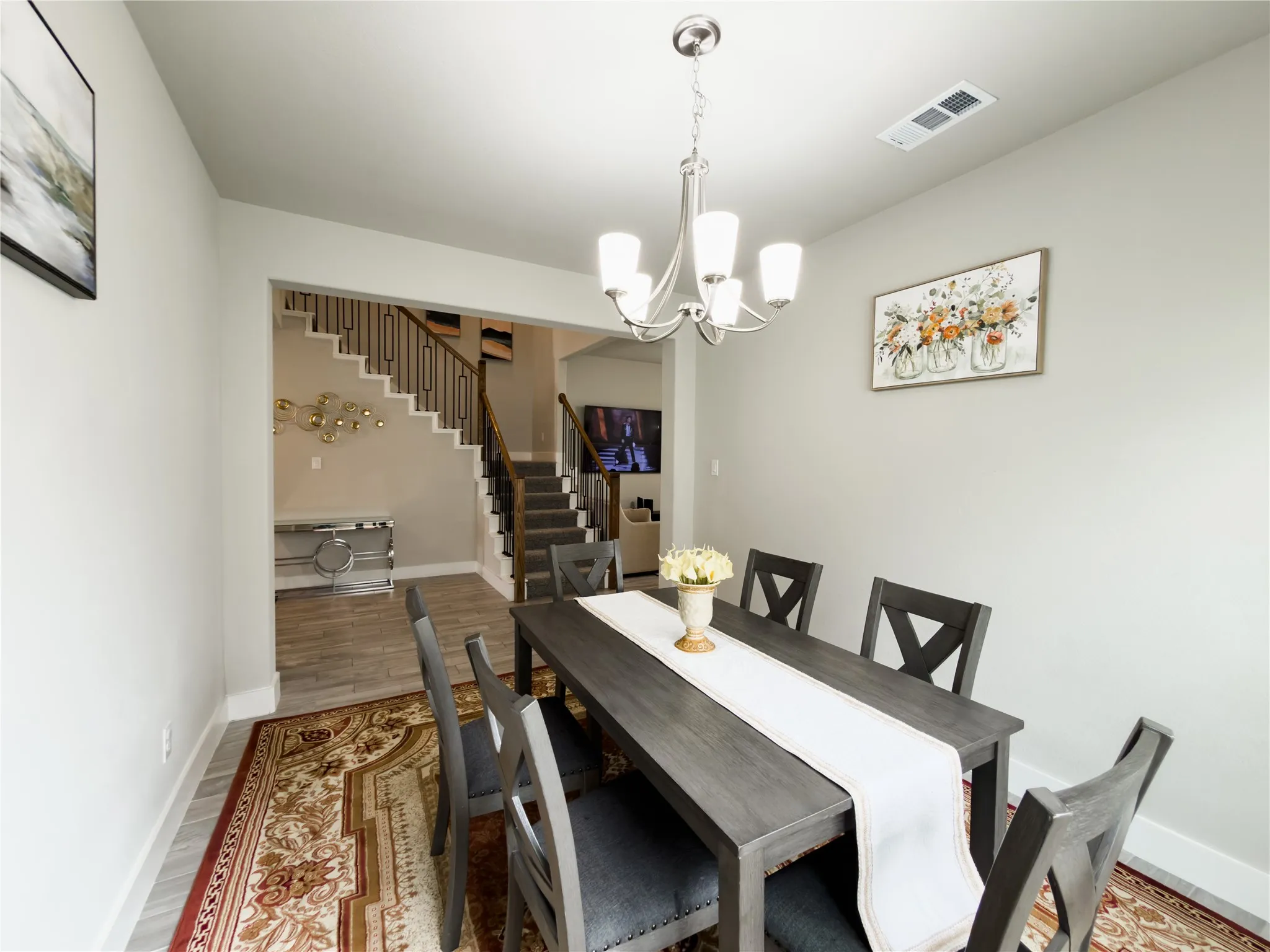Dining room featuring hanging lights and wood finished floors
