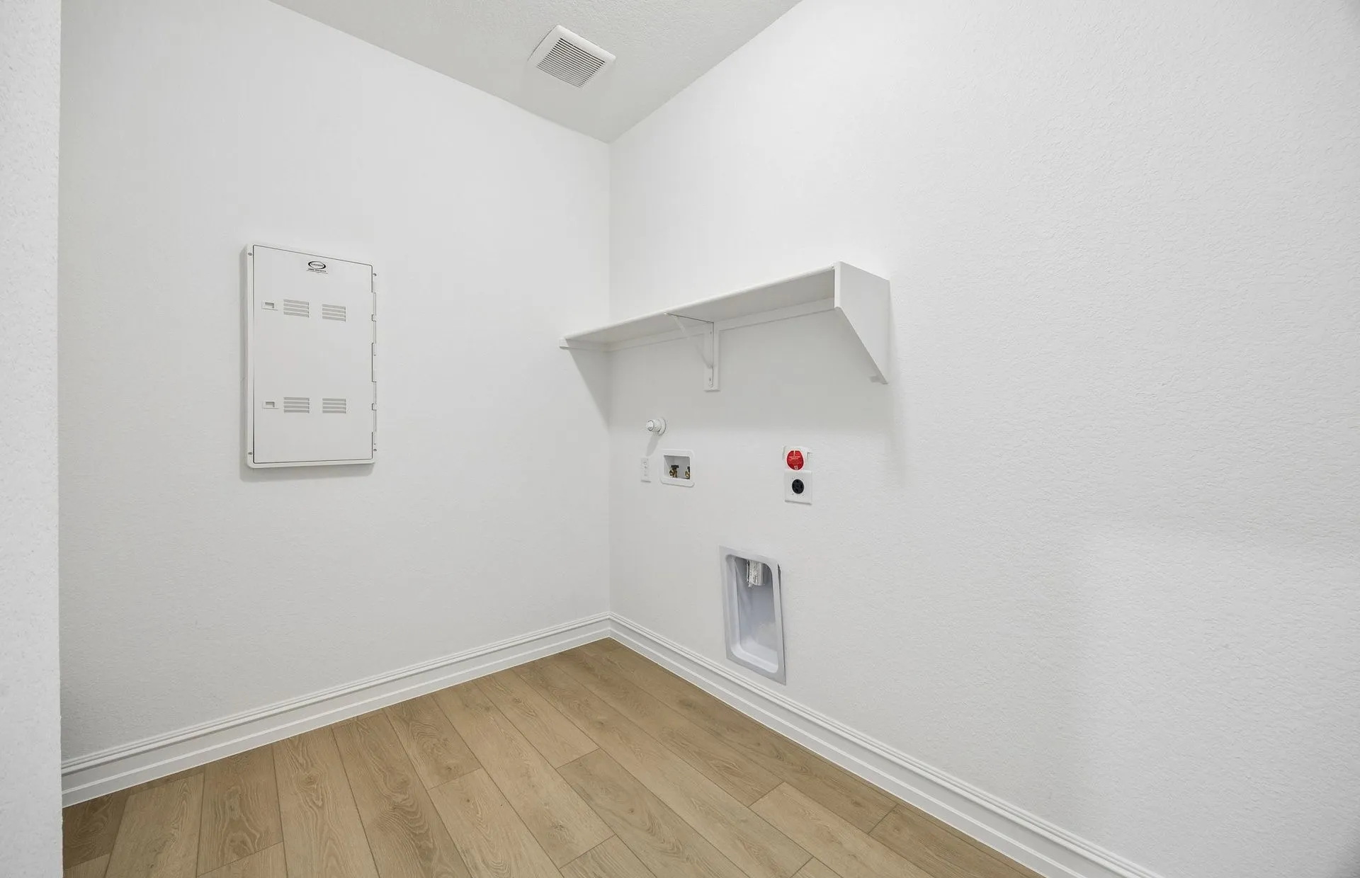 Laundry room with built-in shelving