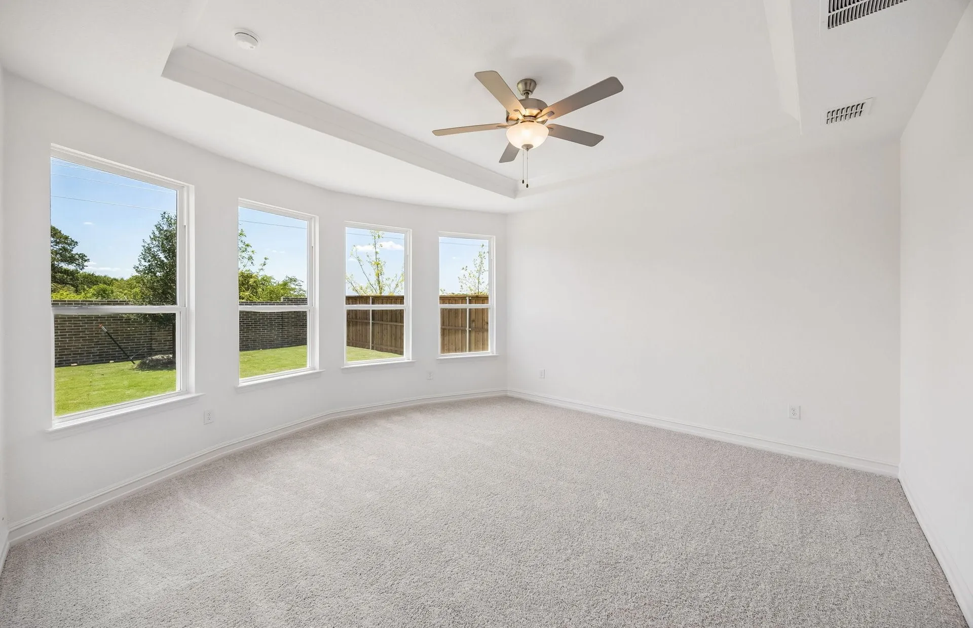 Spacious primary suite with bay windows