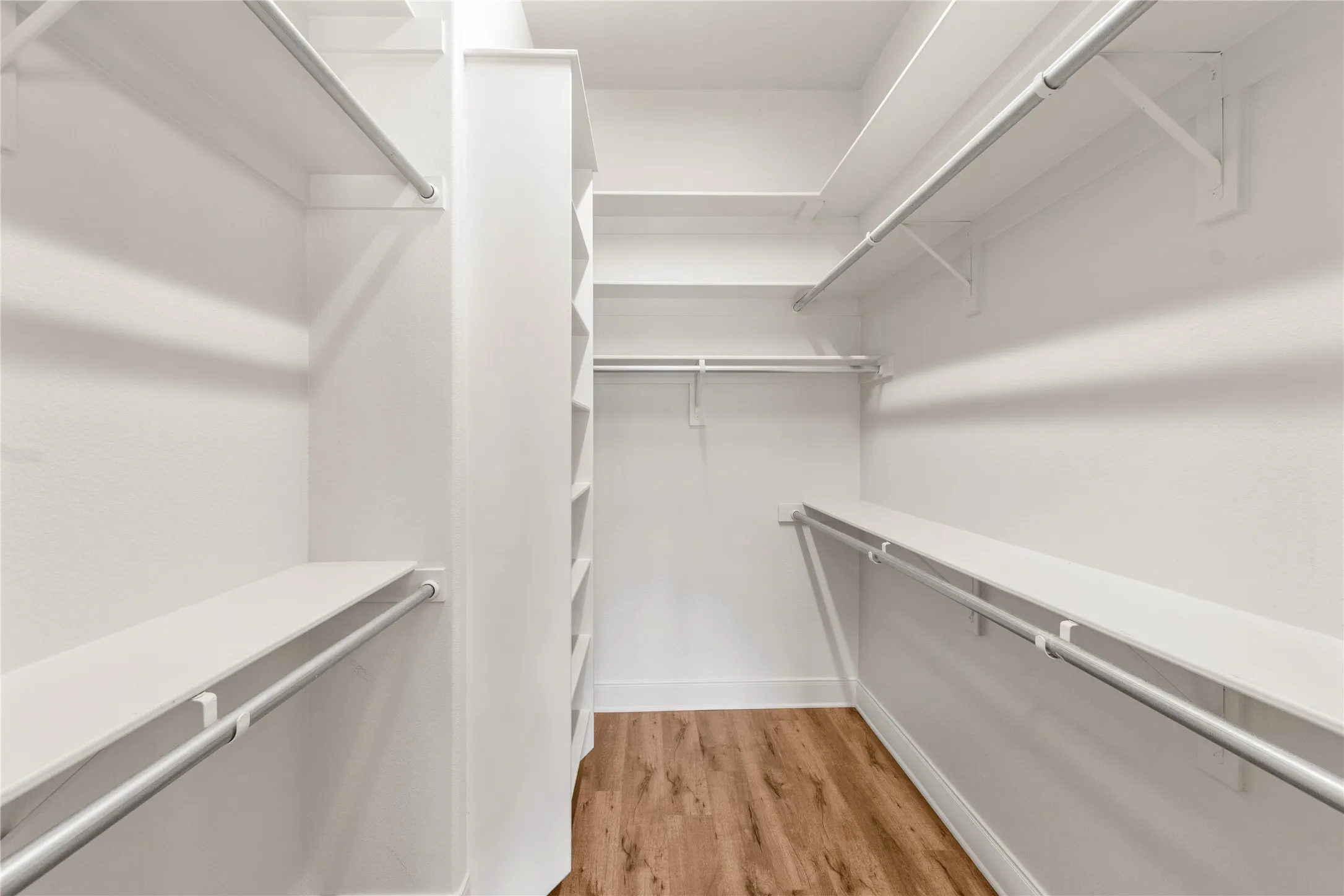 Primary bedroom walk in closet with built ins