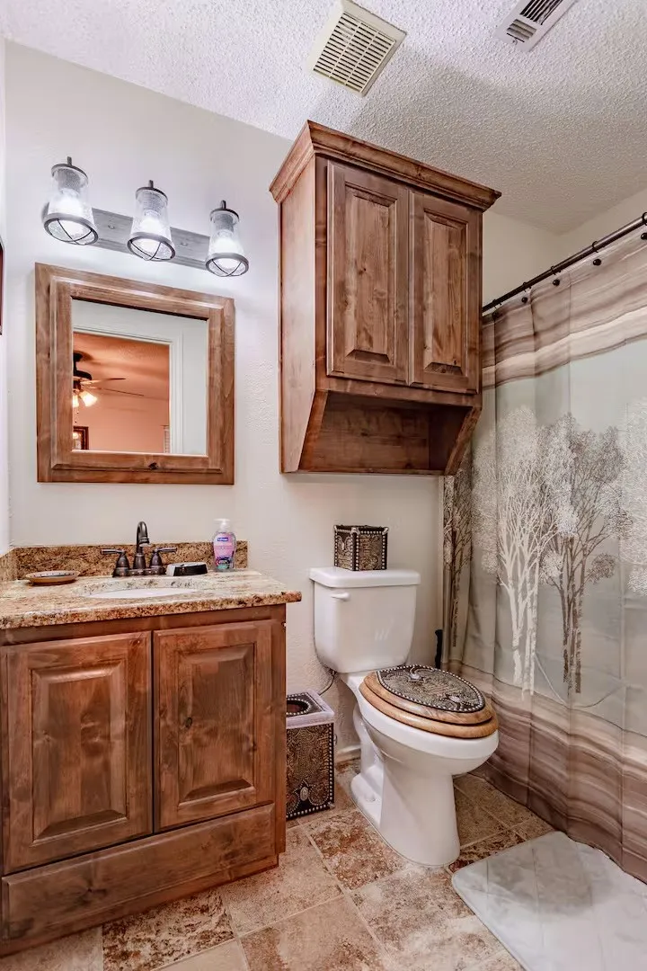 Bathroom featuring vanity, a shower with shower curtain, and a textured ceiling